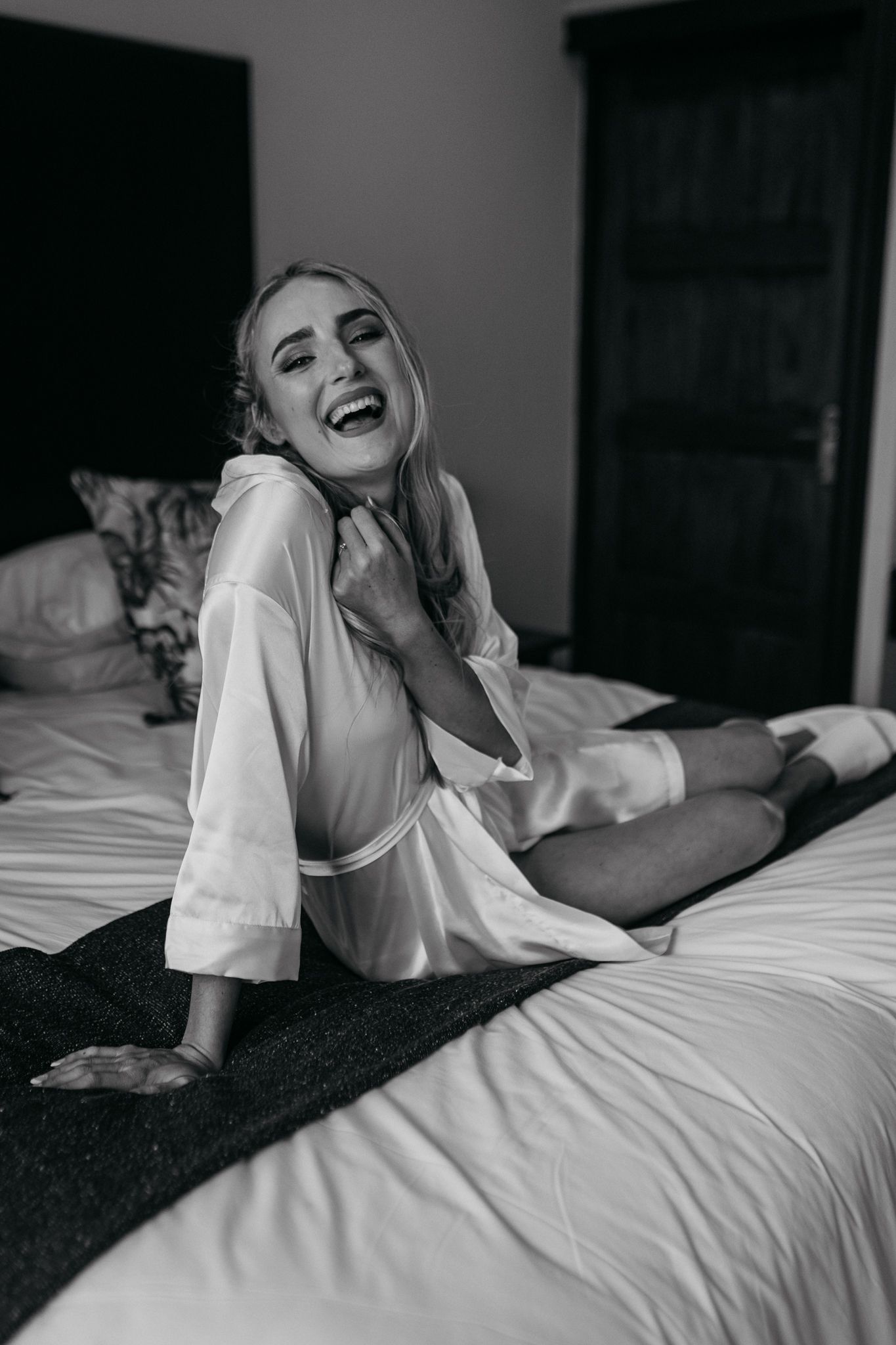 Black and white portrait showing joyful pre-wedding moment.