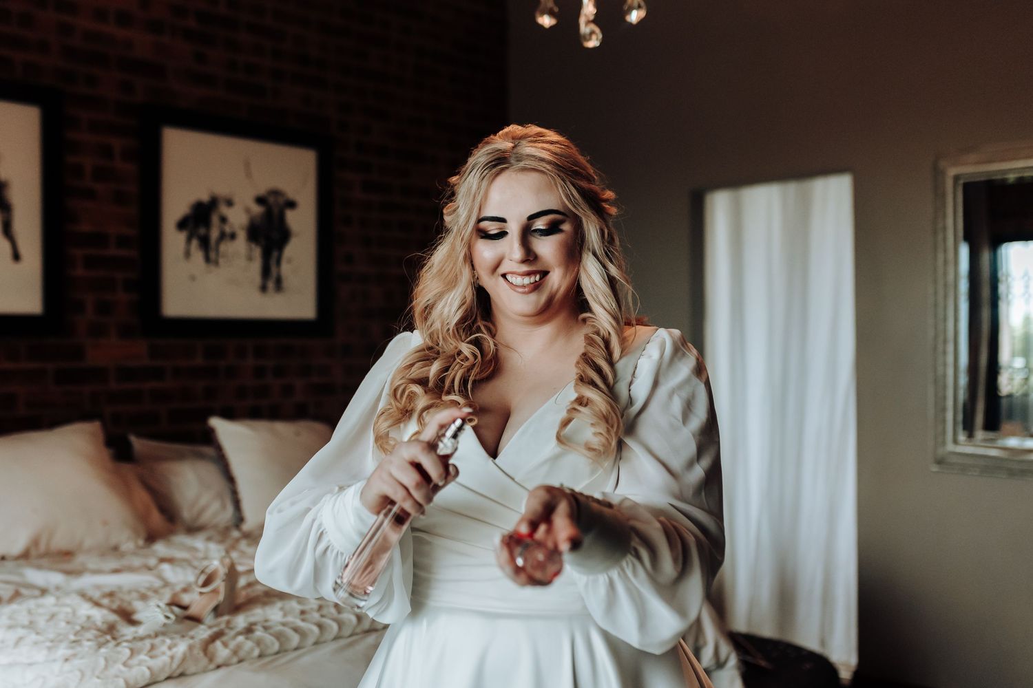 A candid moment showing styled blonde waves and natural joy in a white dress.