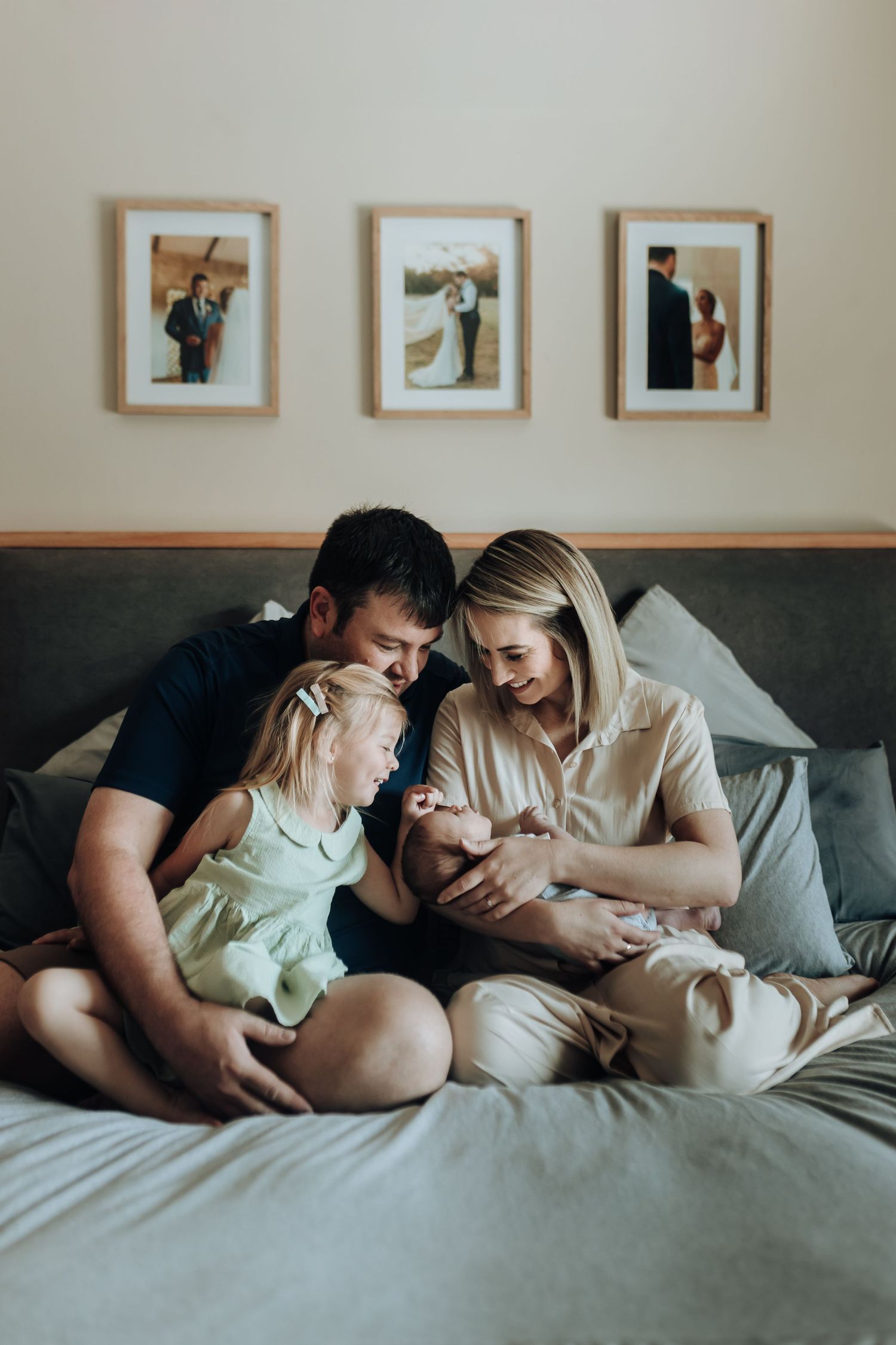 A tender family moment captured in a series of four intimate photos showing loving interactions on a bed.