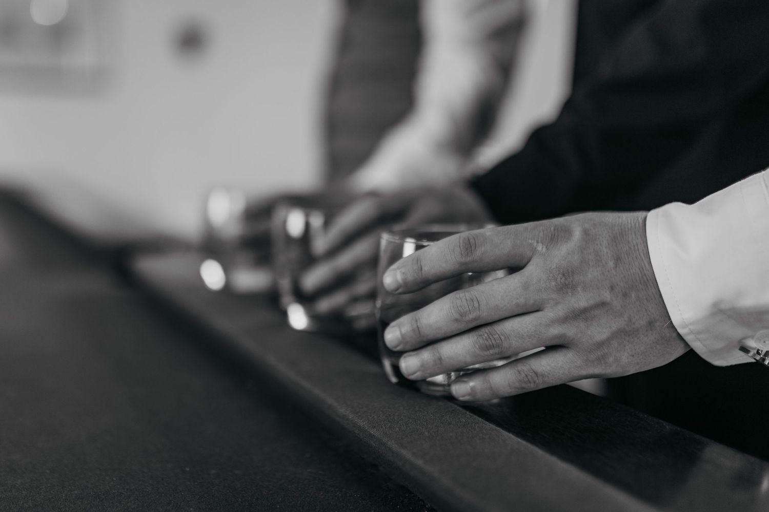 Close-up shot of hands preparing food in a professional kitchen setting.