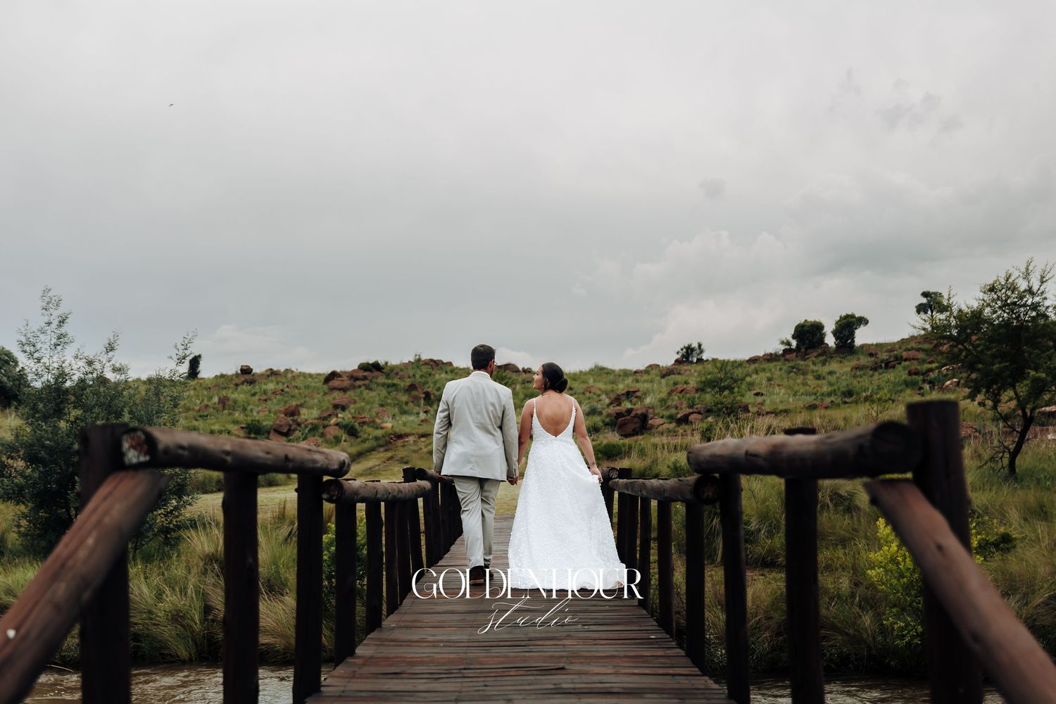 Scenic outdoor wedding venue with rustic wooden fencing and natural landscape.