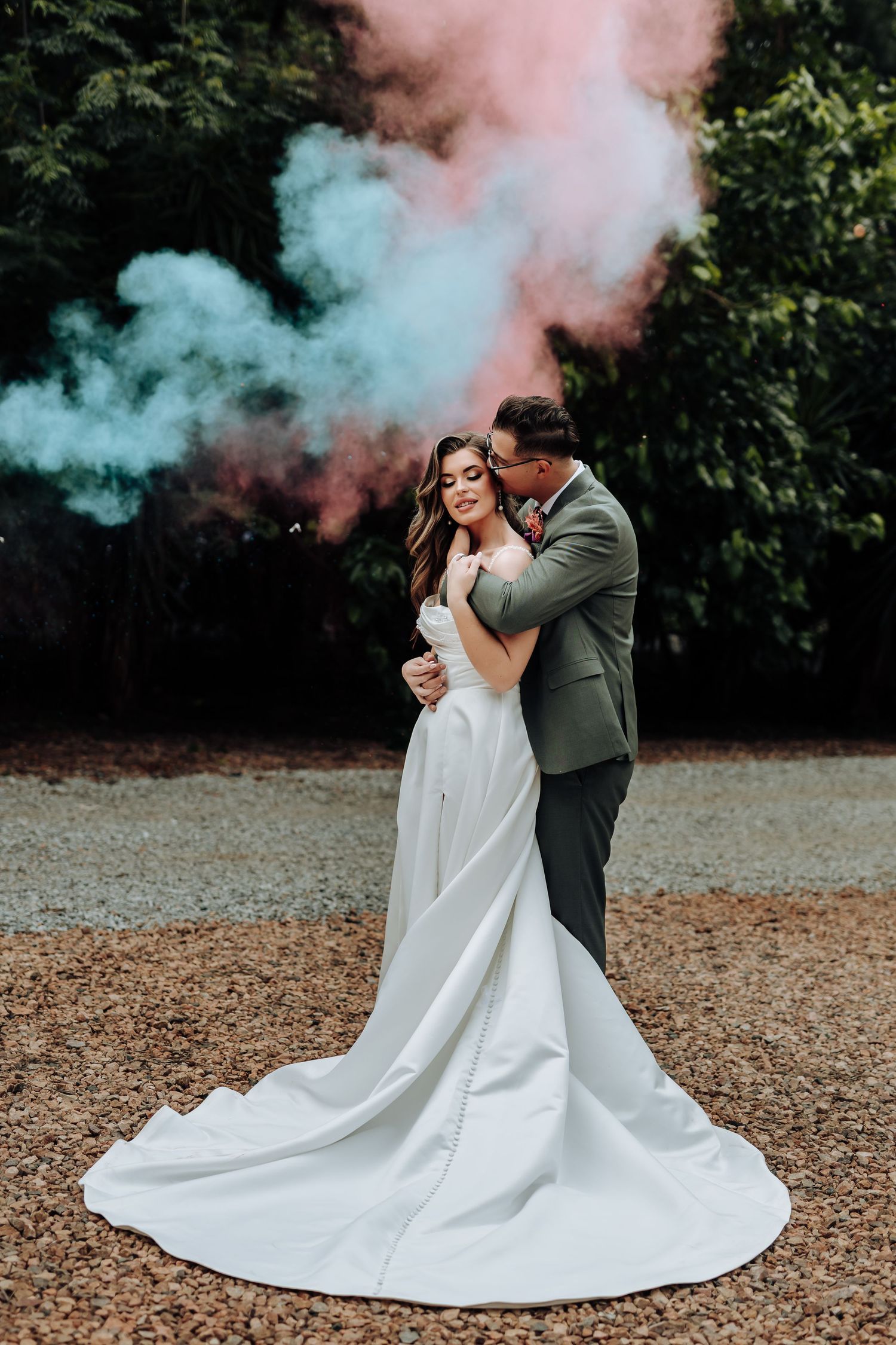 Romantic wedding photo sequence with colorful smoke bombs creating dreamy teal and pink effects in an outdoor setting.