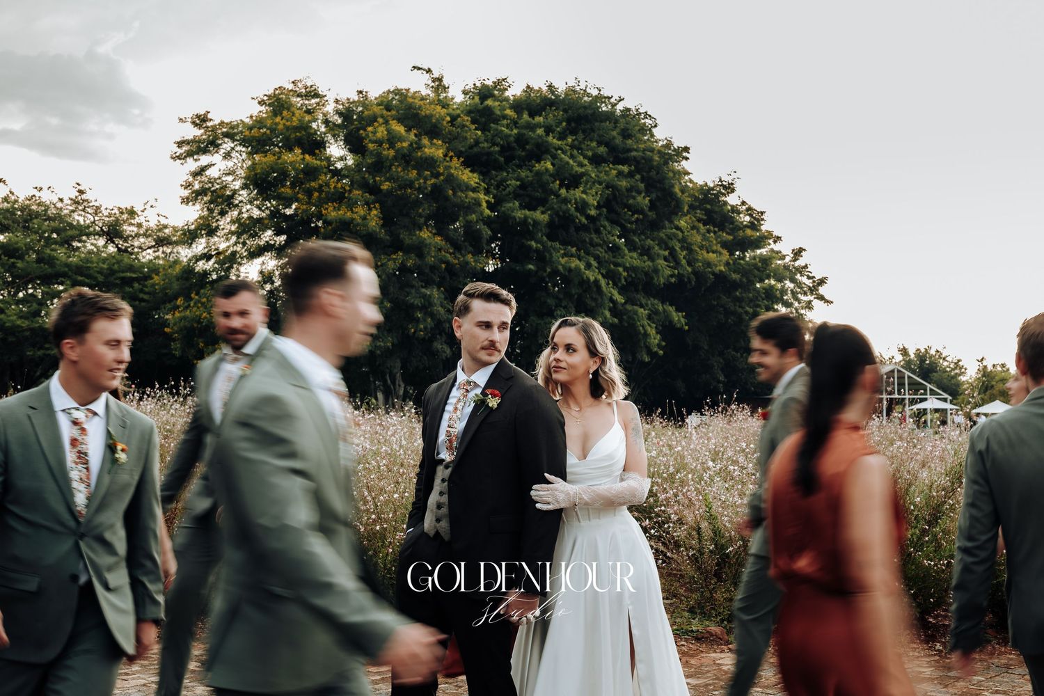Wedding guests mingling during outdoor reception with blurred motion effect.