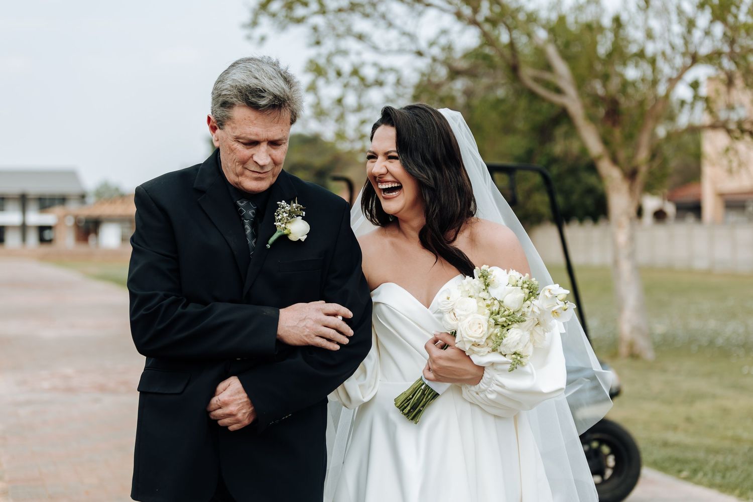 Bride and groom share an intimate moment during their wedding photoshoot in an outdoor setting.