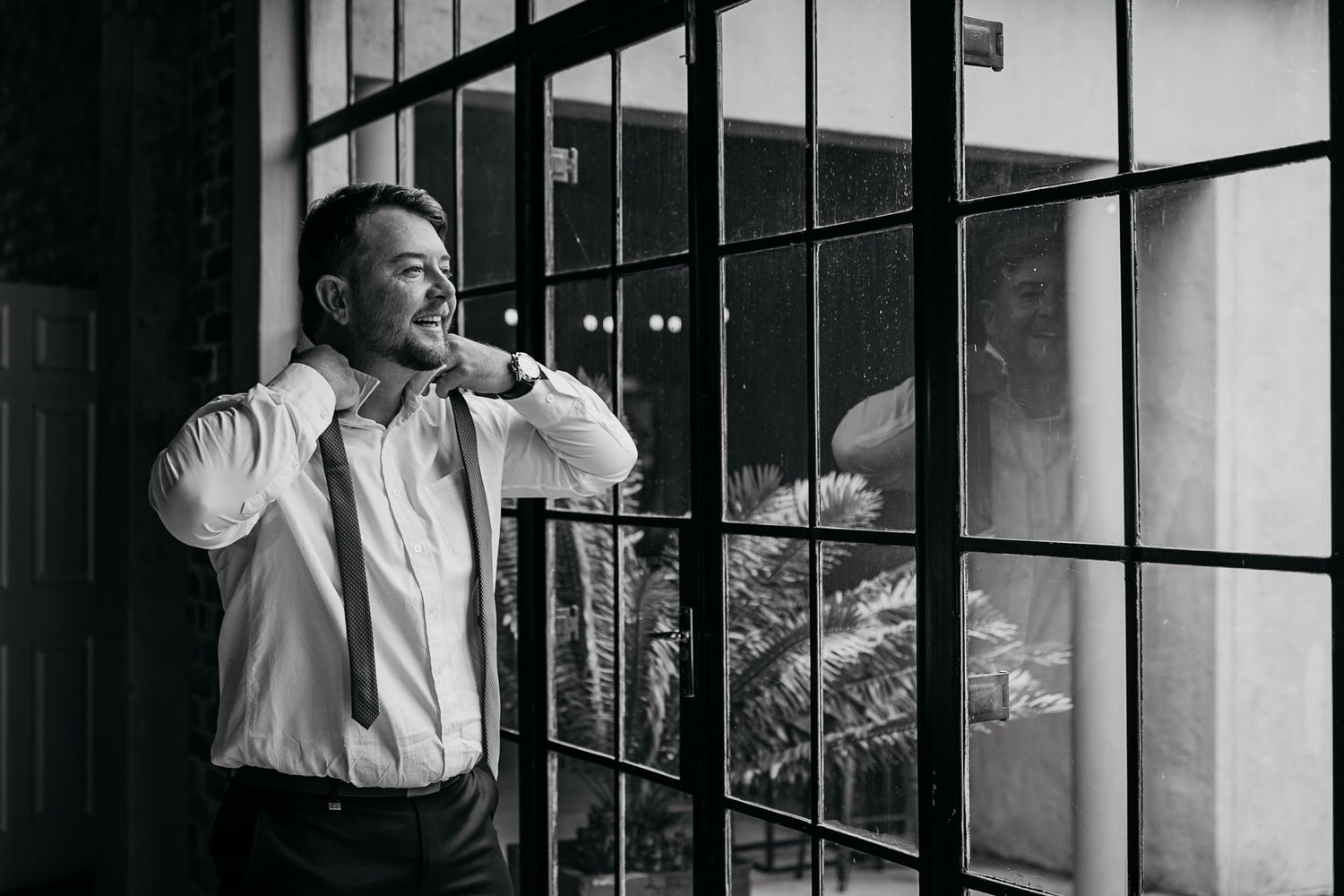 A black and white photo series showing a person in a white shirt looking through prison bars from different angles.