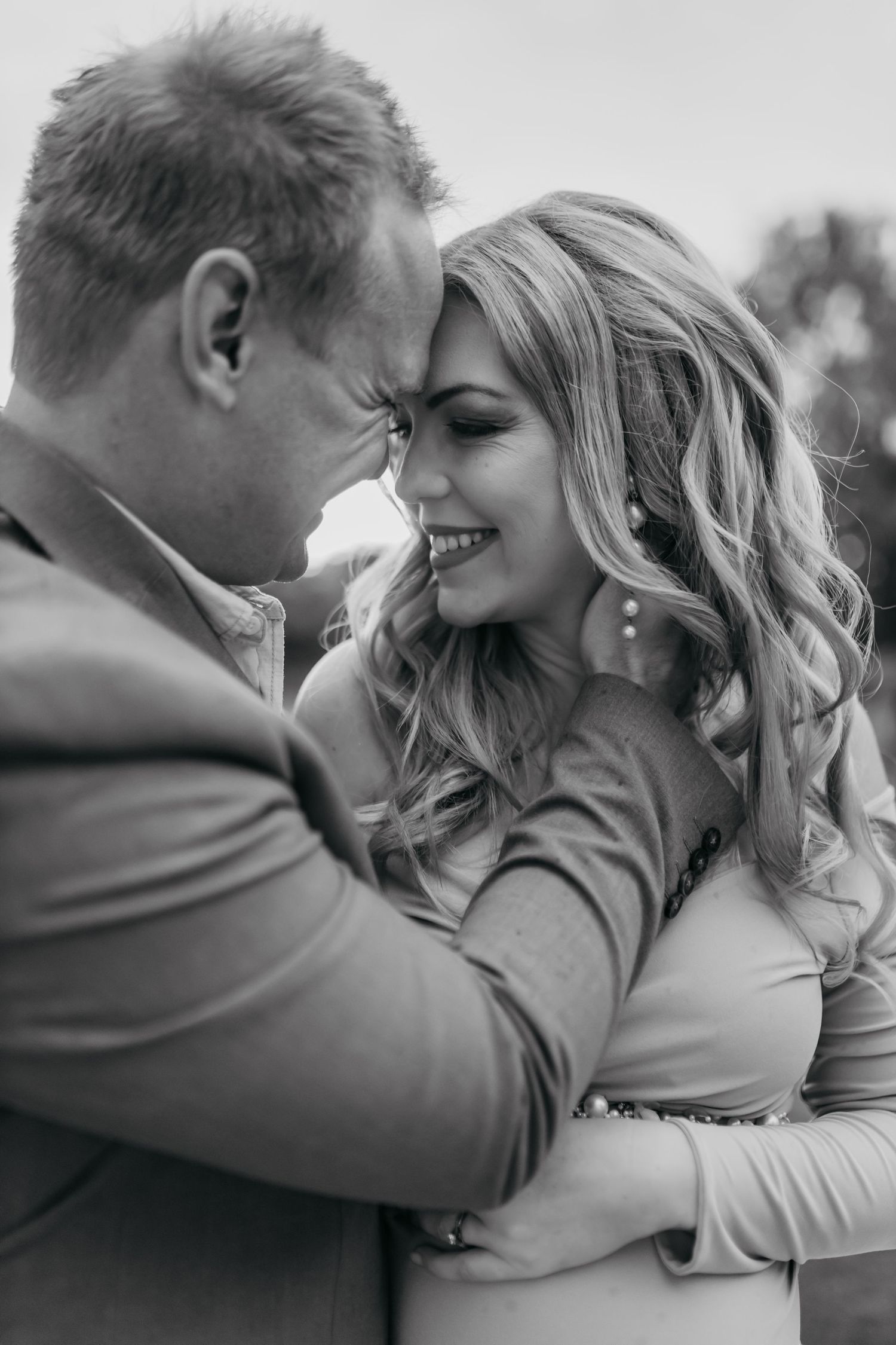 Black and white romantic photo sequence showing intimate moments between a couple in loving embrace.