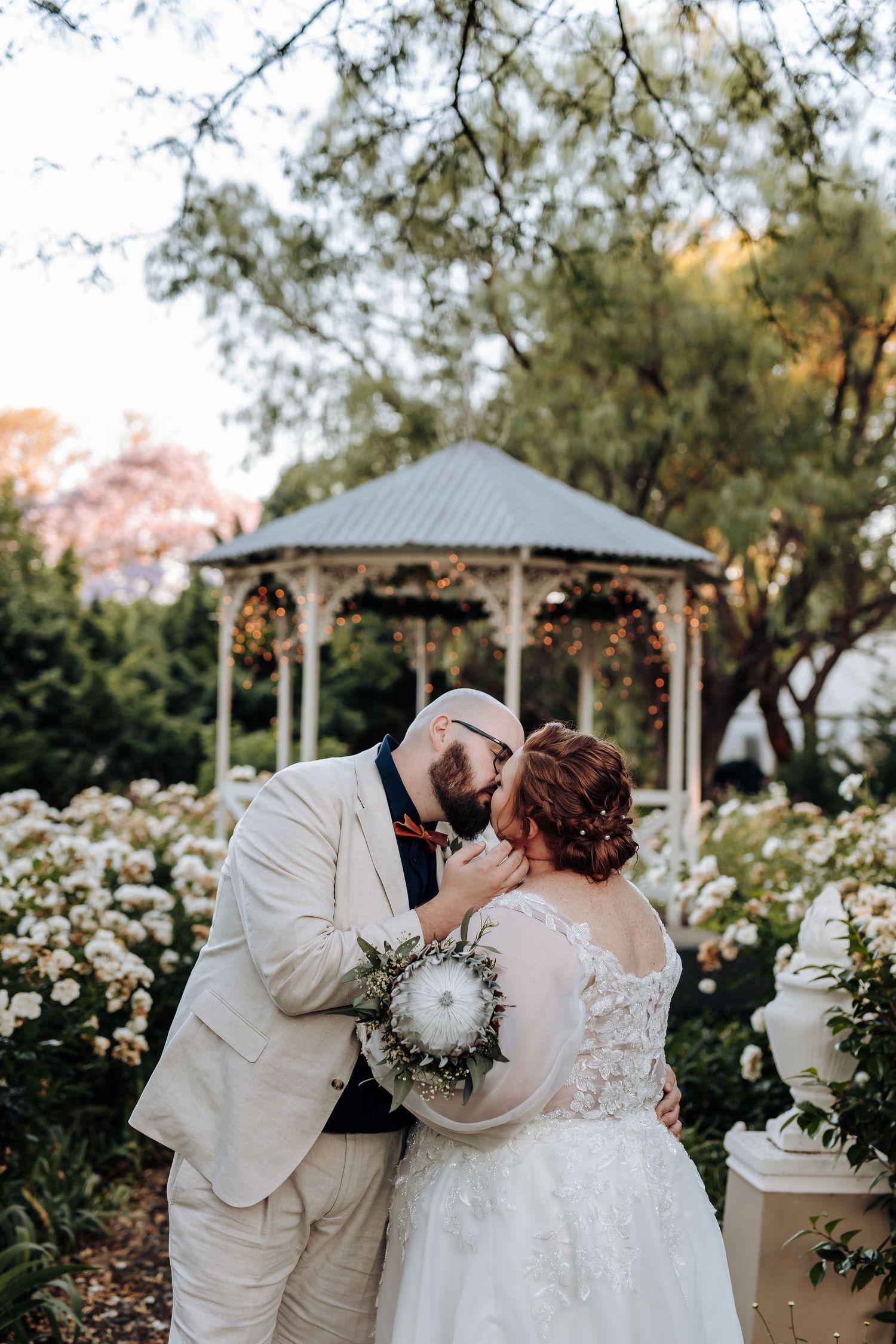 A romantic wedding photoshoot series showing tender moments between a couple in a garden setting with gazebos.