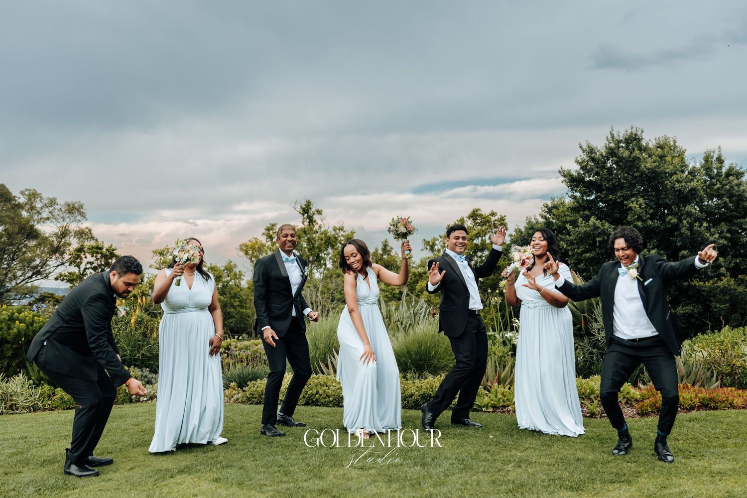 Fun group photos of wedding party striking dynamic poses outdoors.
