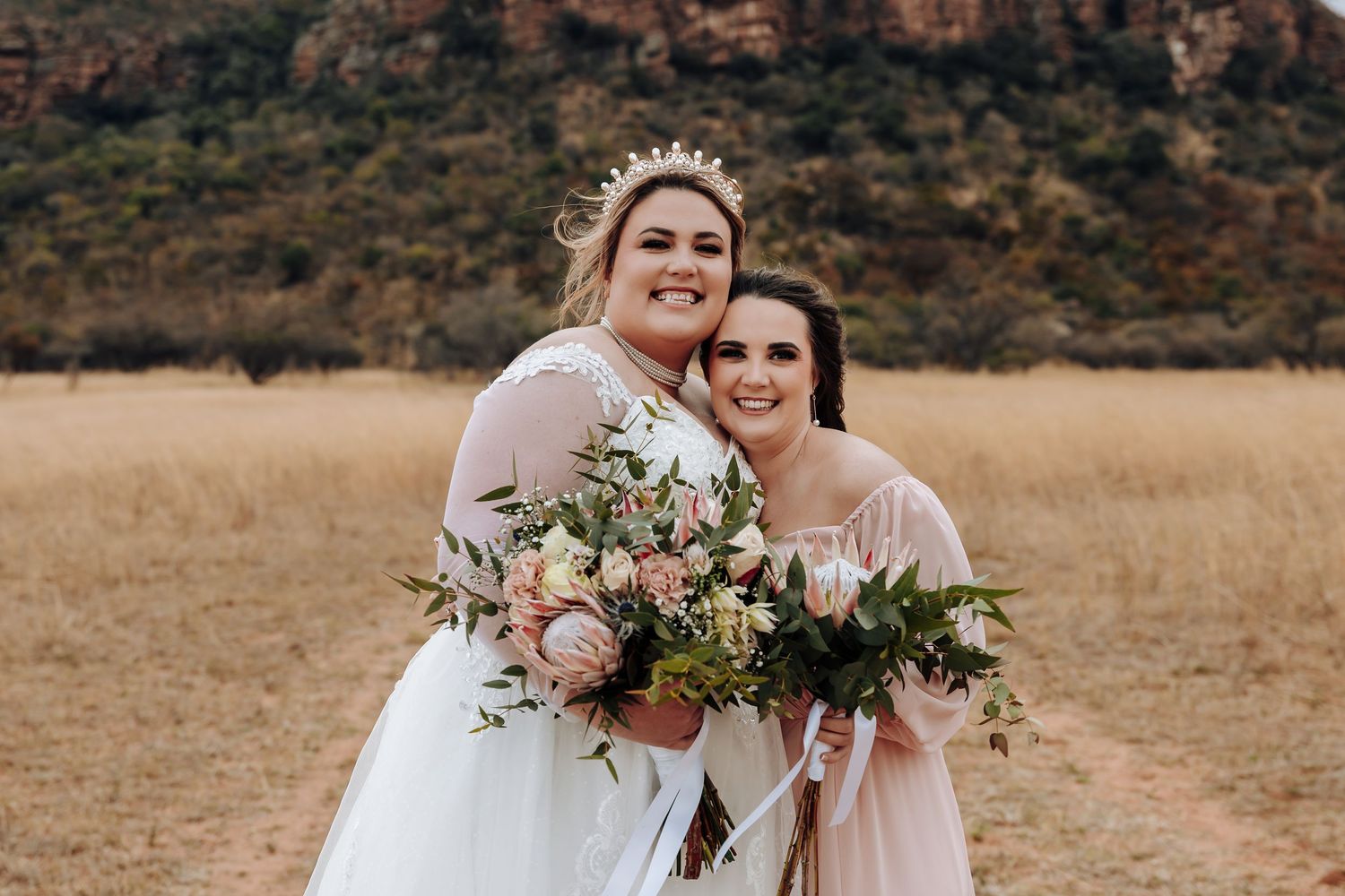 Stylish wedding couple shares intimate moments in a beautiful golden meadow setting for their nature-inspired portraits.