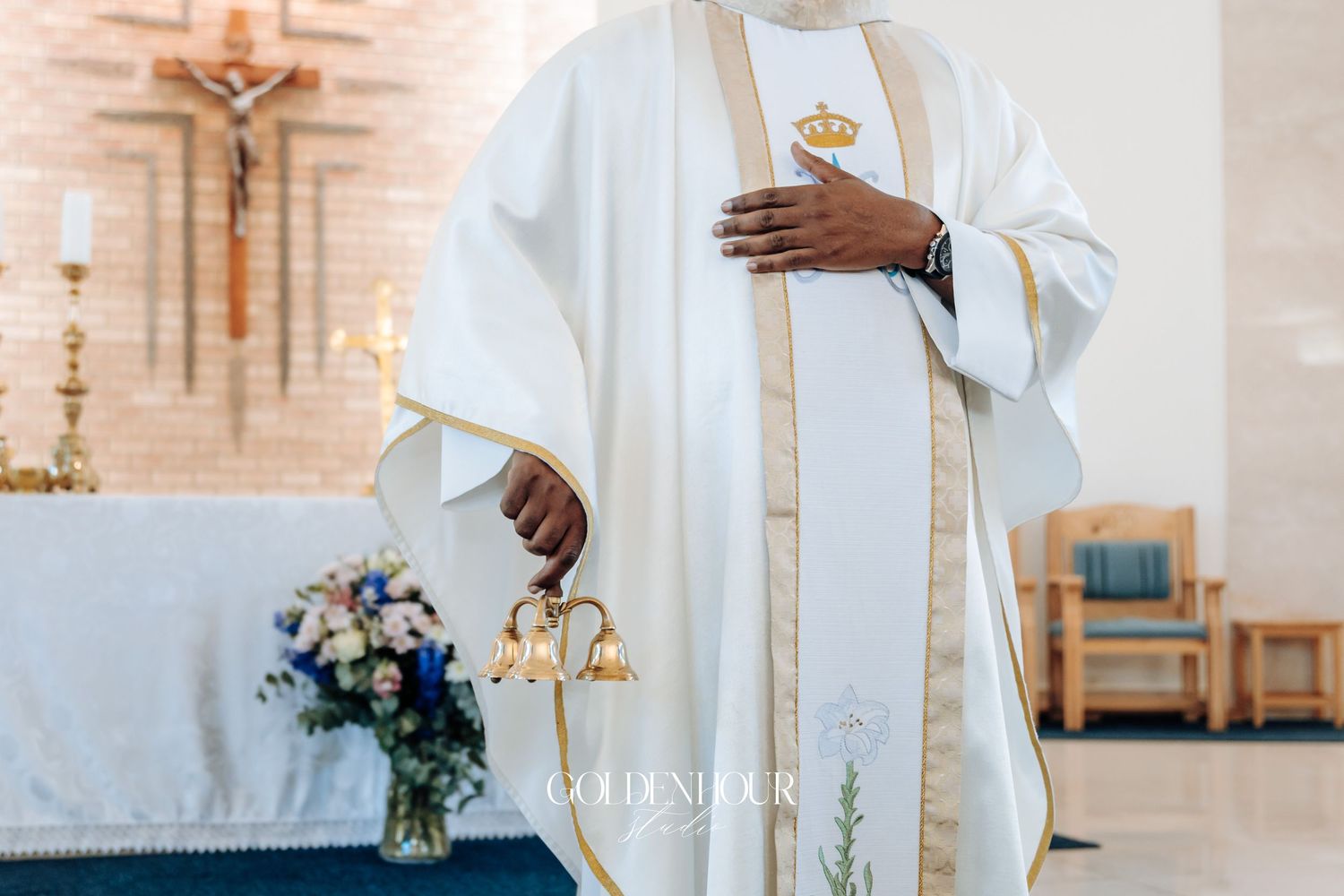 Priest in white robes conducting a wedding ceremony in a church.
