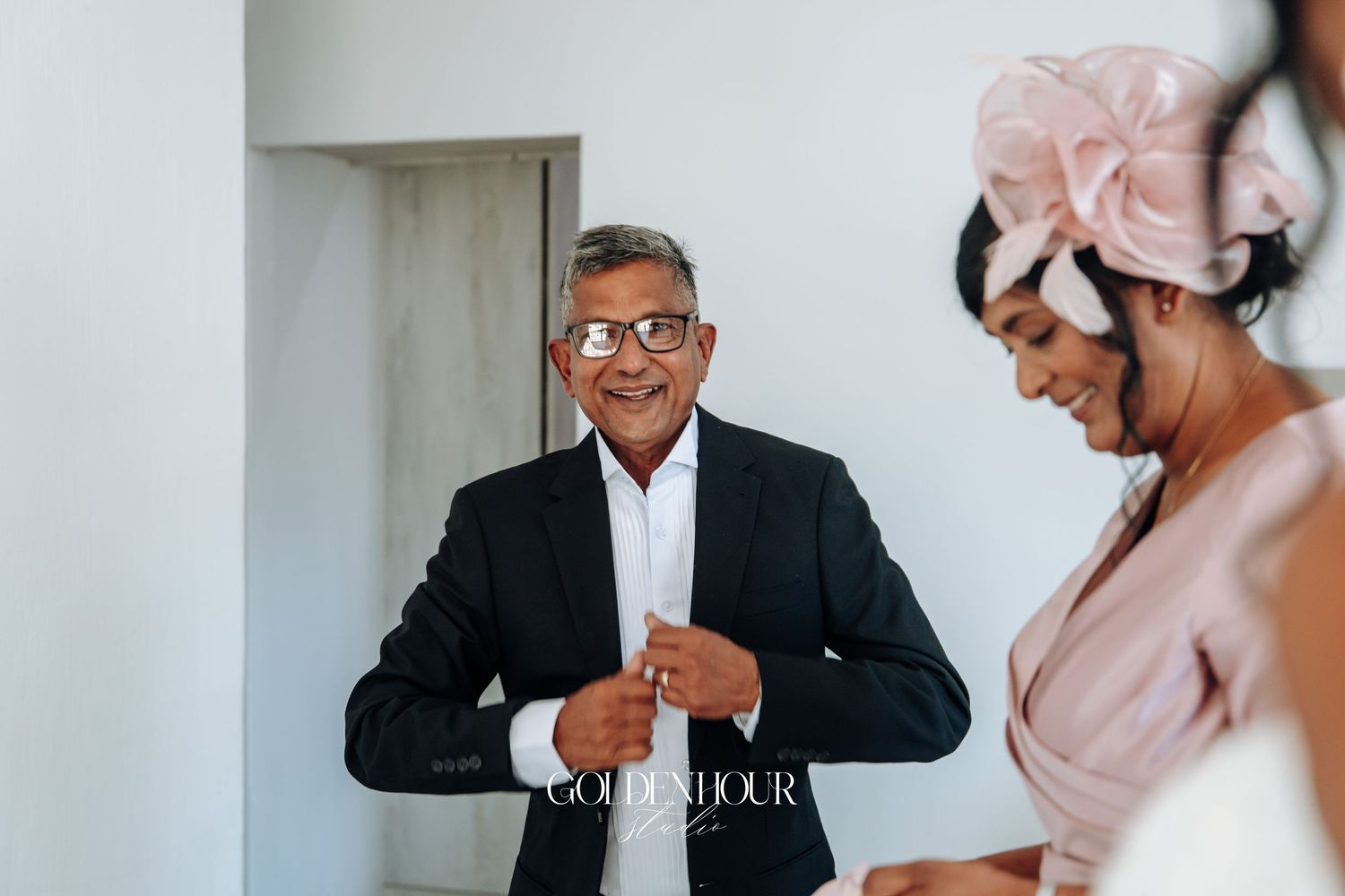 Emotional wedding preparation moment captured in a light-filled room.