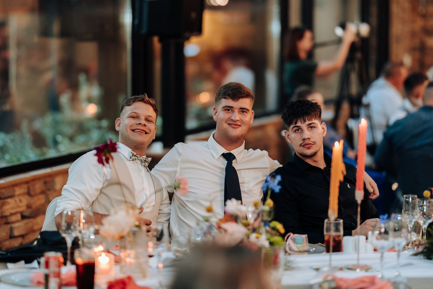 Wedding reception dinner with candlelit tables and festive decorations.