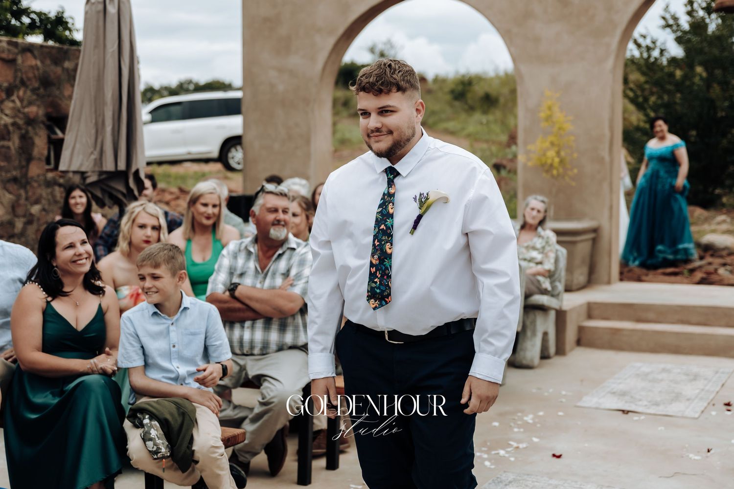 Guests enjoying outdoor wedding reception under stone archways.
