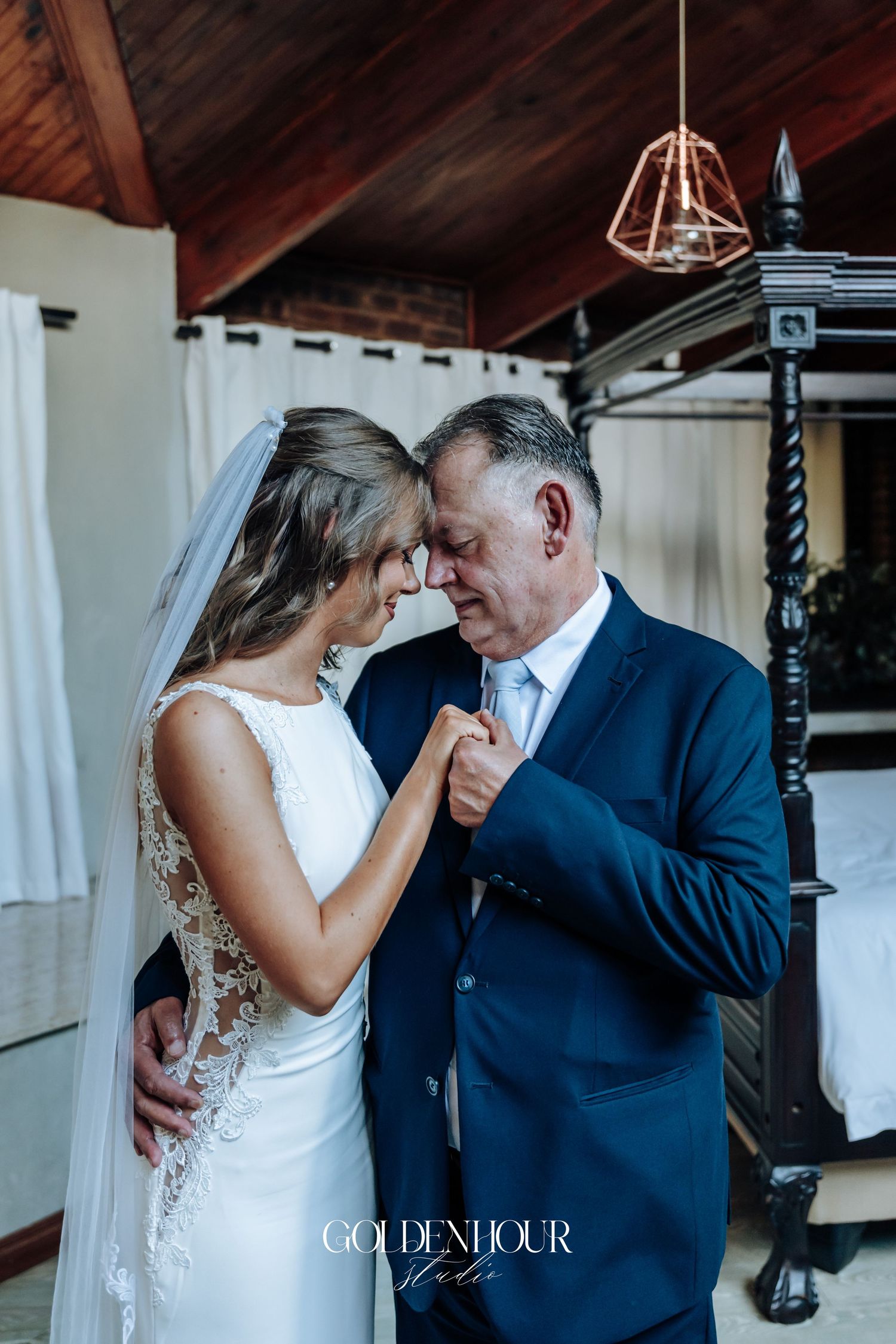 Romantic wedding dance moment captured in elegant indoor venue.
