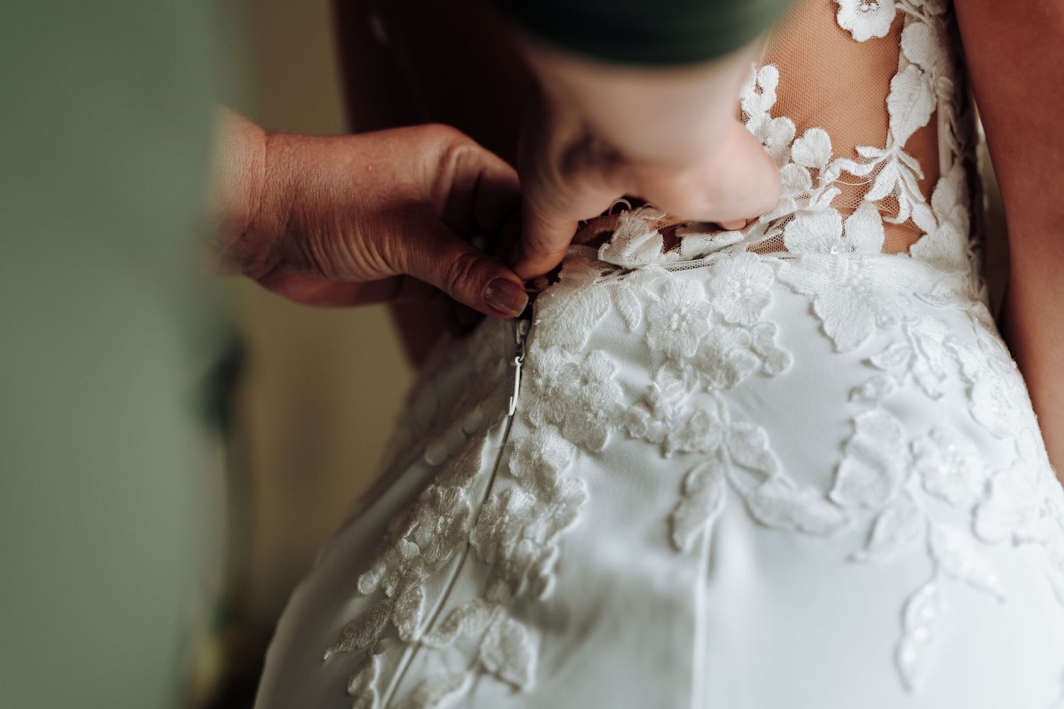 Close-up shots showing delicate details of a white wedding dress with lace, floral appliques and beaded embellishments.