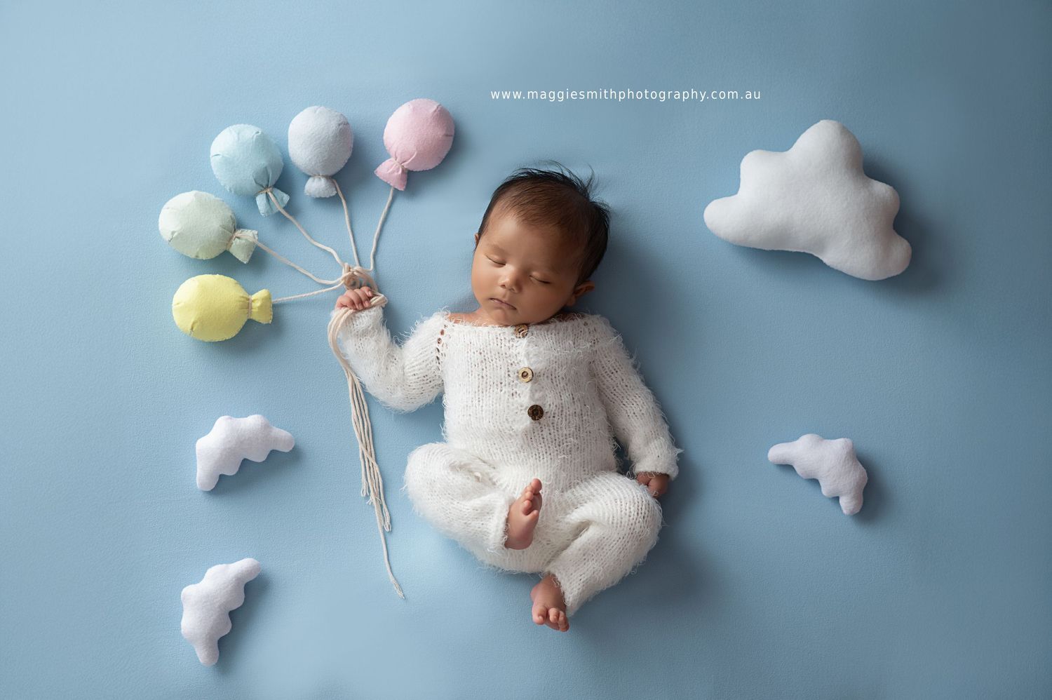 Newborn photography collage with soft pastel clouds, teddy bears, and balloons in dreamy blue tones.