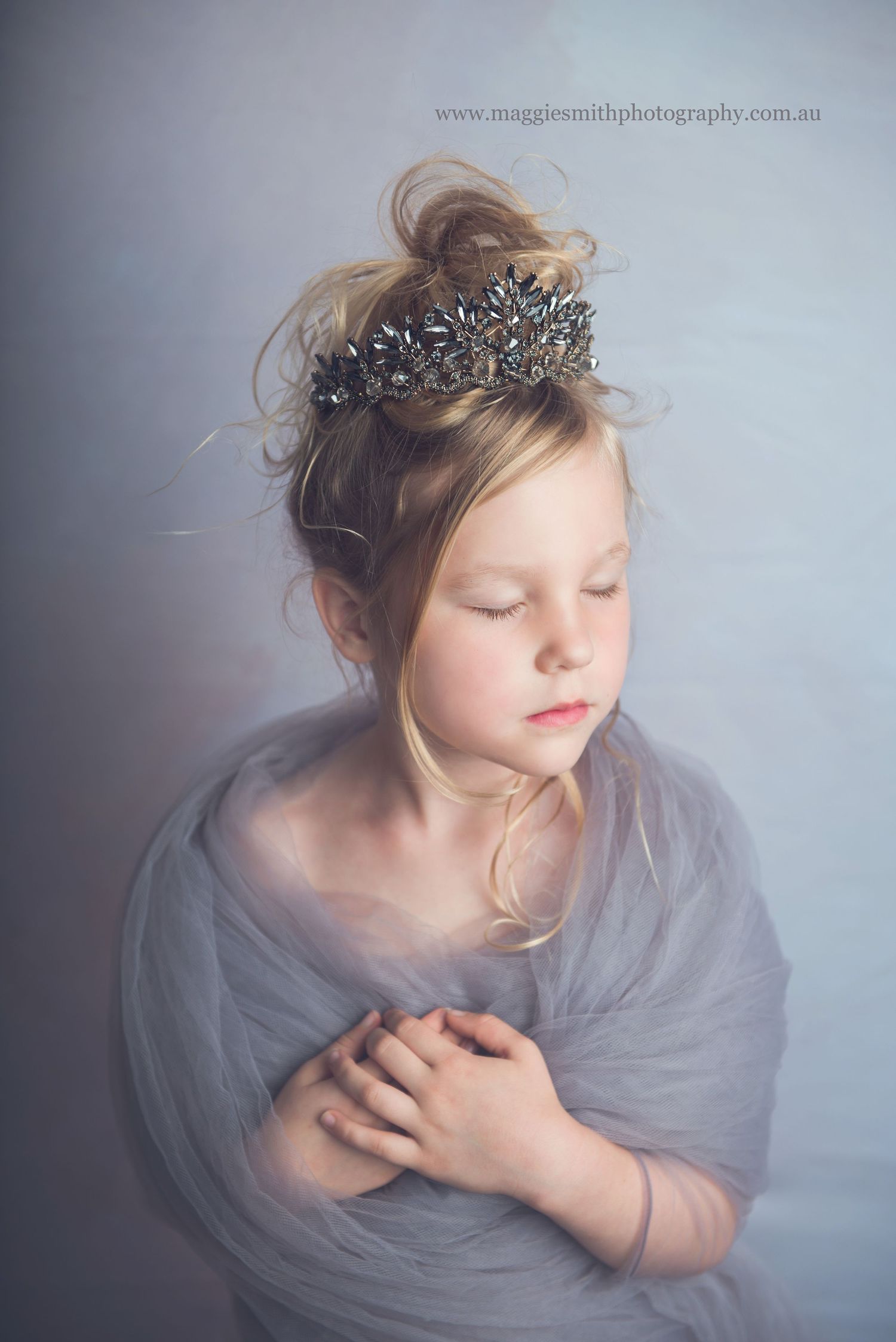 Artistic portrait series showing ethereal poses in soft gray tones with delicate crown and flowing movement. Girl photography