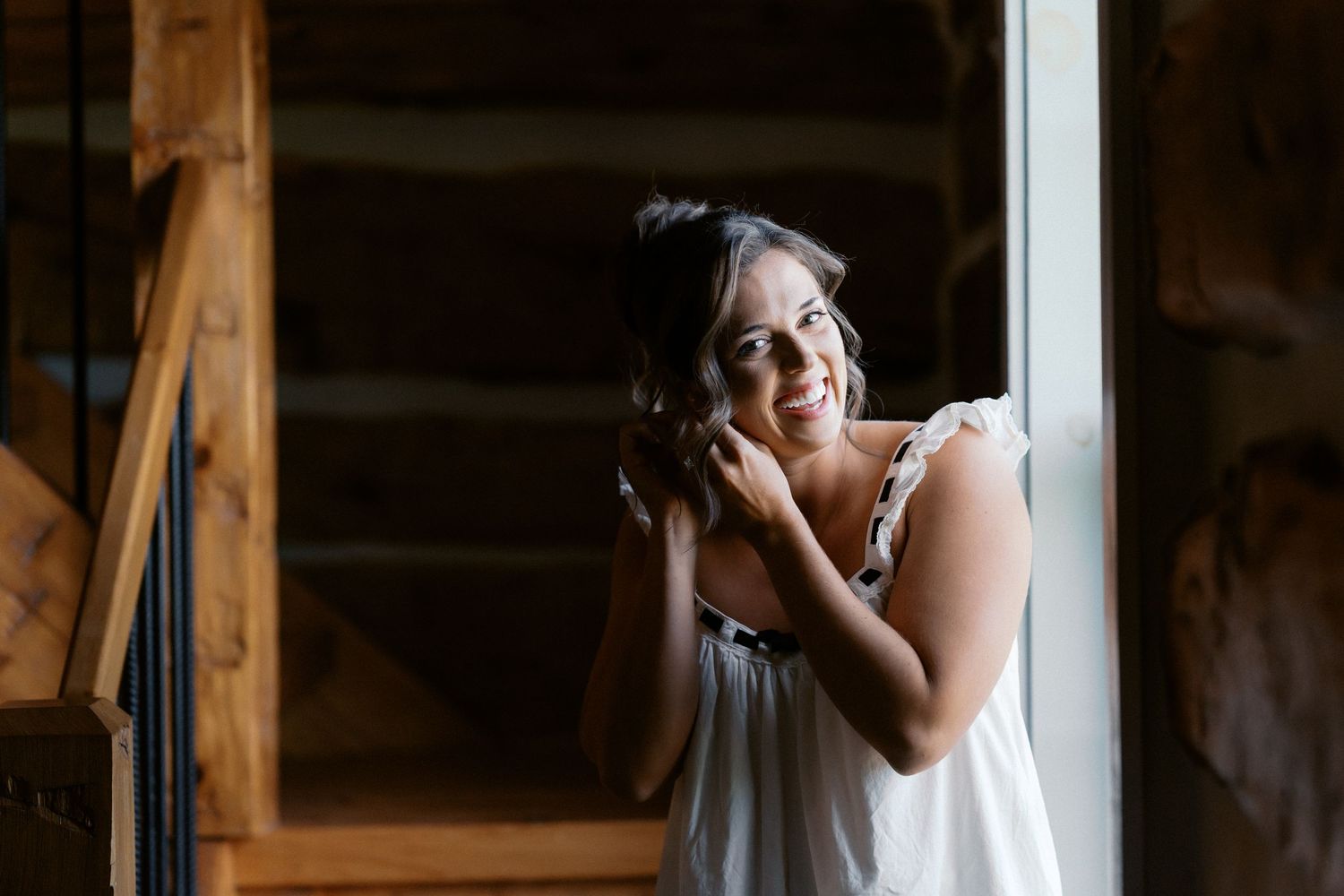 A candid moment captured by a window in soft natural light.
