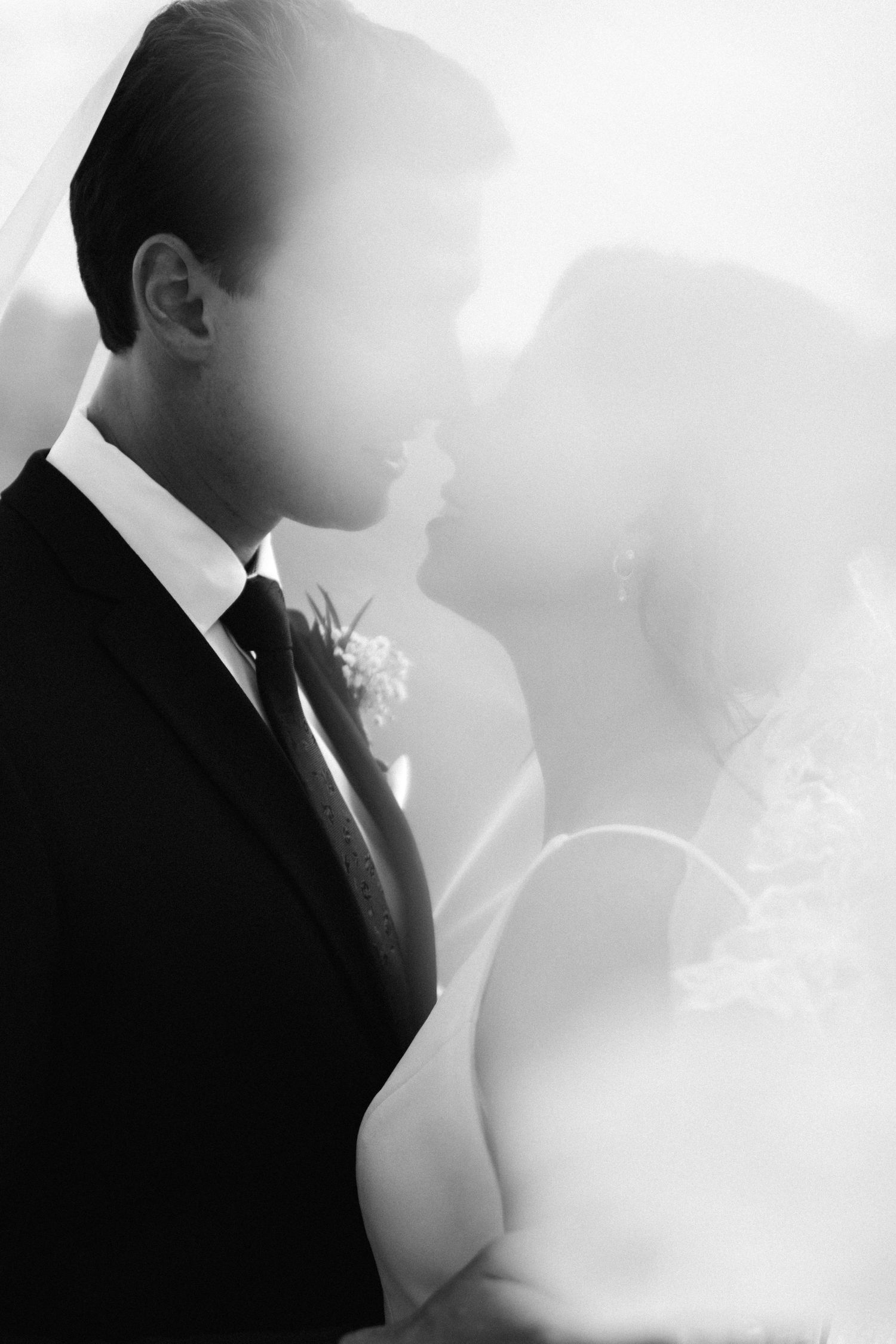 Romantic black and white close-up of a wedding couple sharing an intimate moment together.