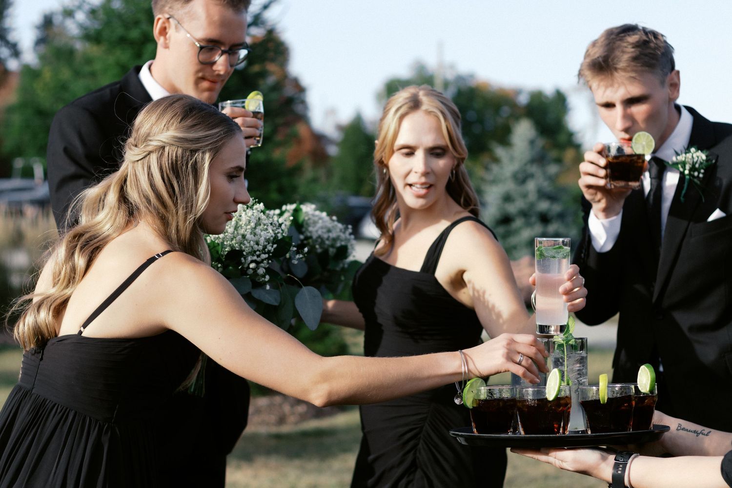 Wedding party enjoying drinks and celebrations outdoors.