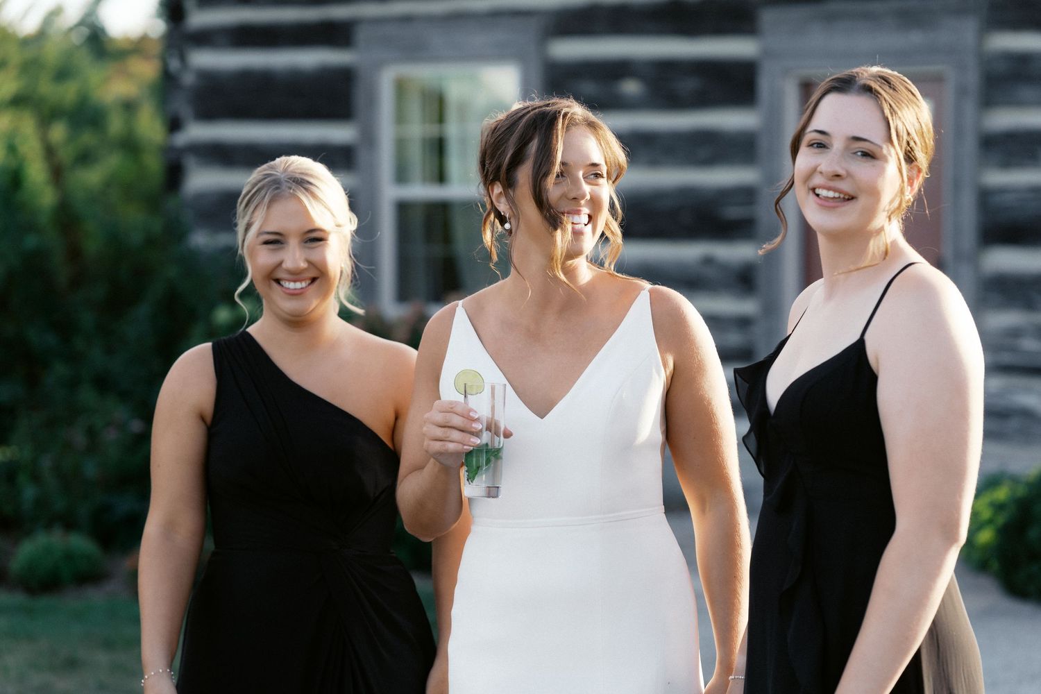 Wedding party celebrating outdoors in formal attire.