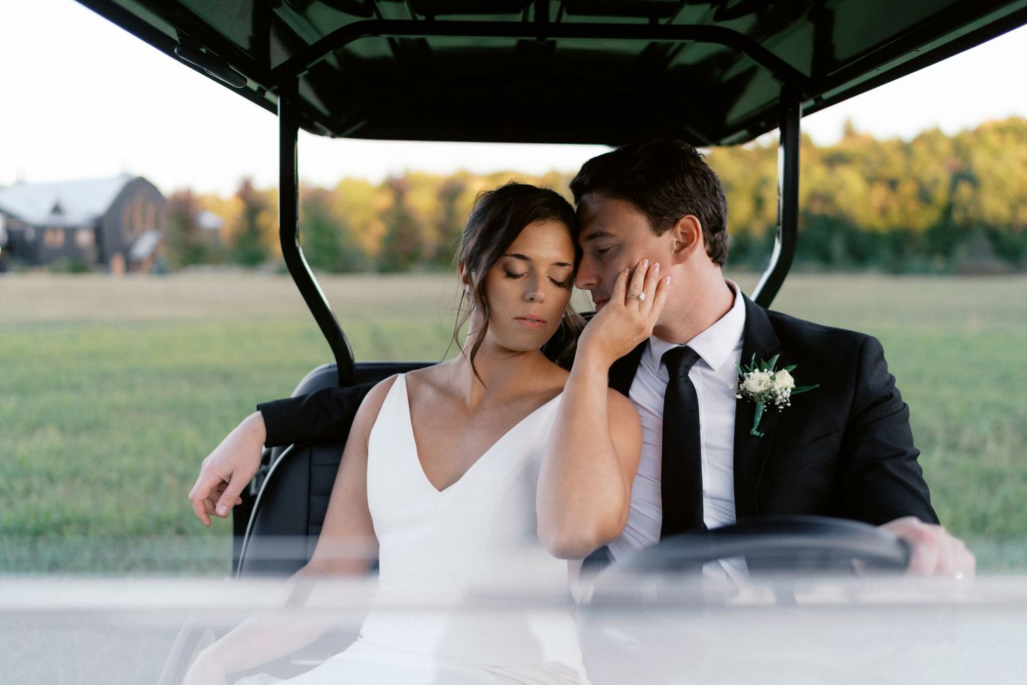 Wedding couple shares intimate moments inside a covered outdoor venue.