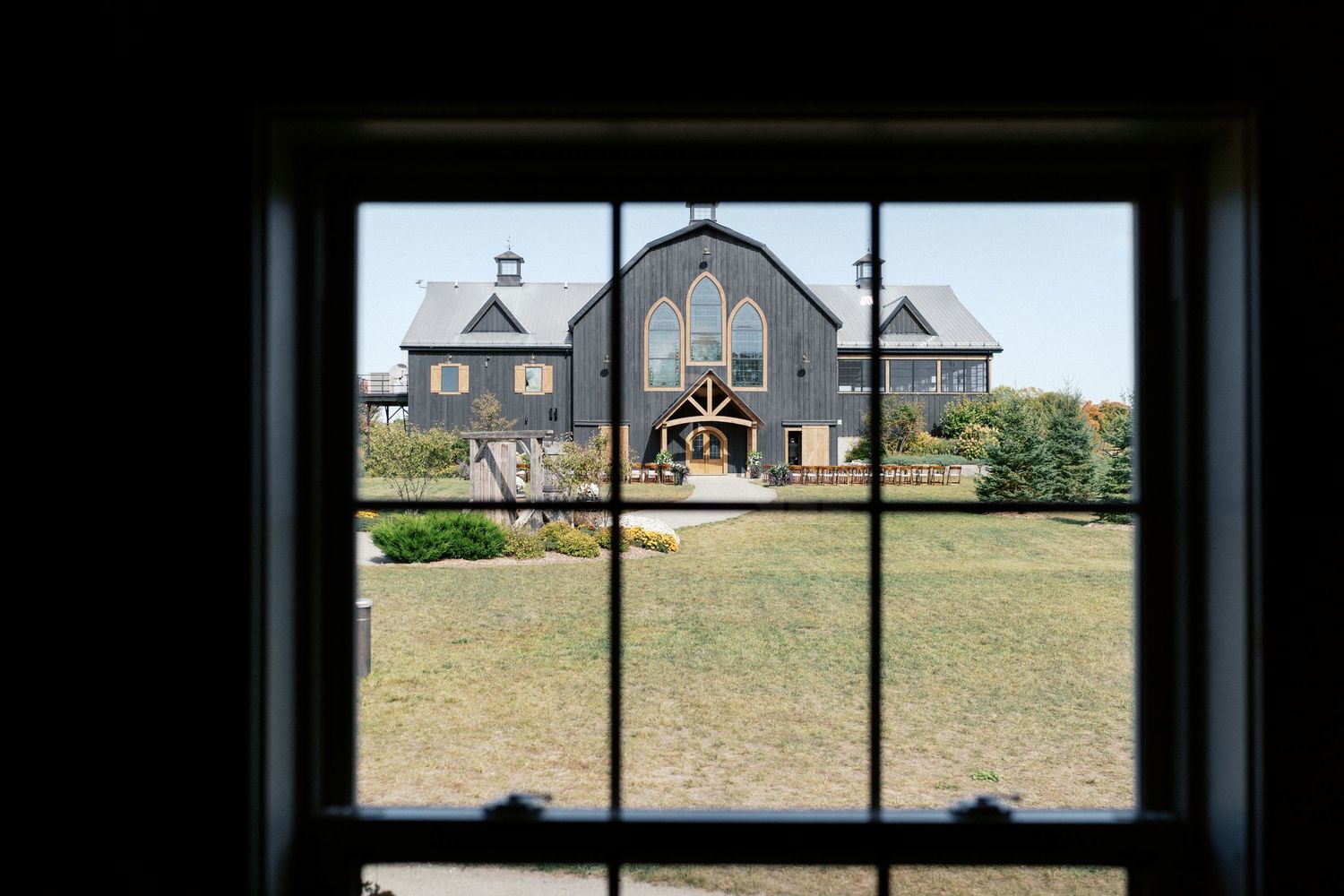 View of a rustic barn through multiple window panes creating a panoramic effect.