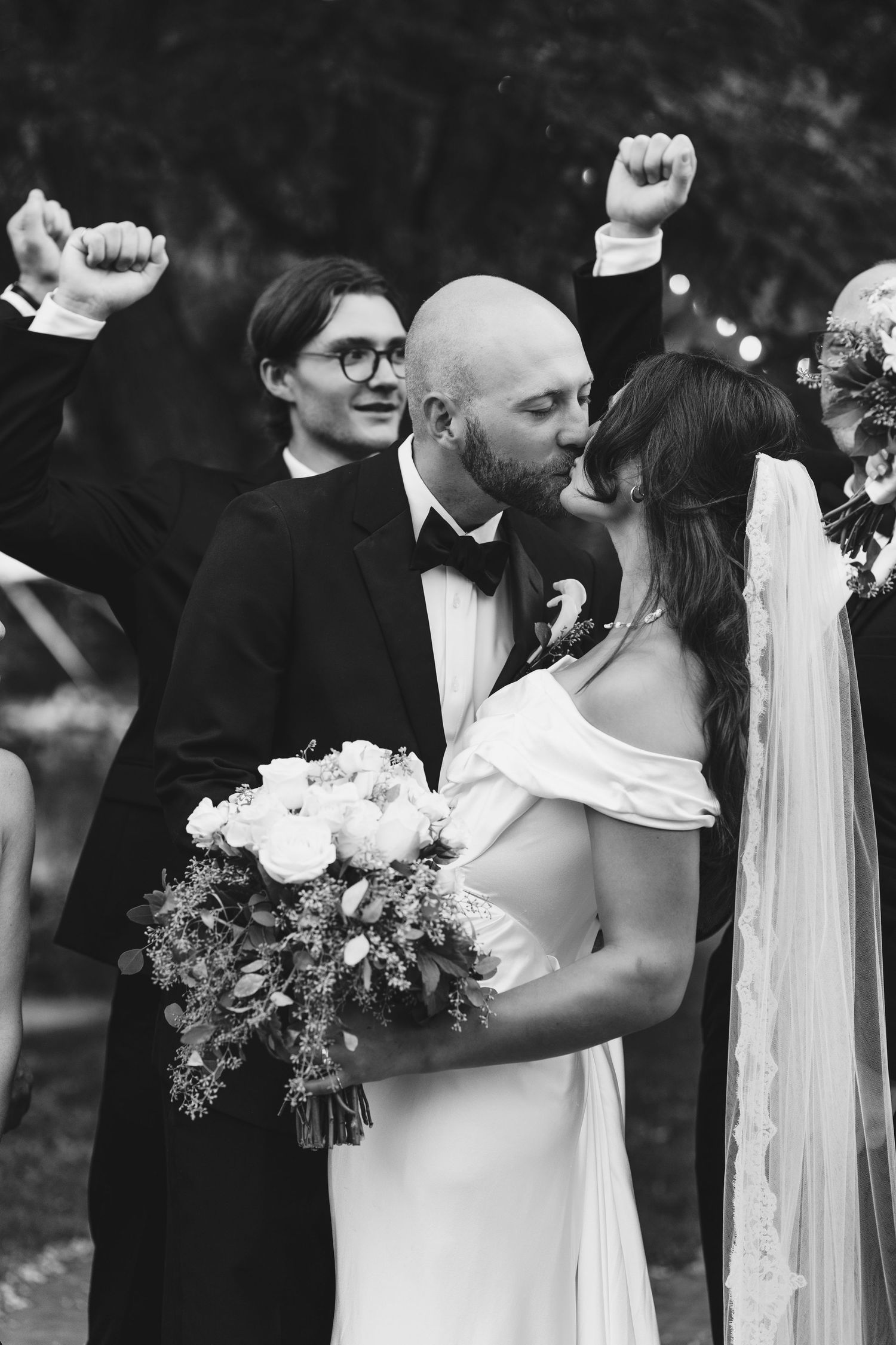 Black and white wedding photo collage showing romantic moments between newlyweds with floral bouquets and veils.