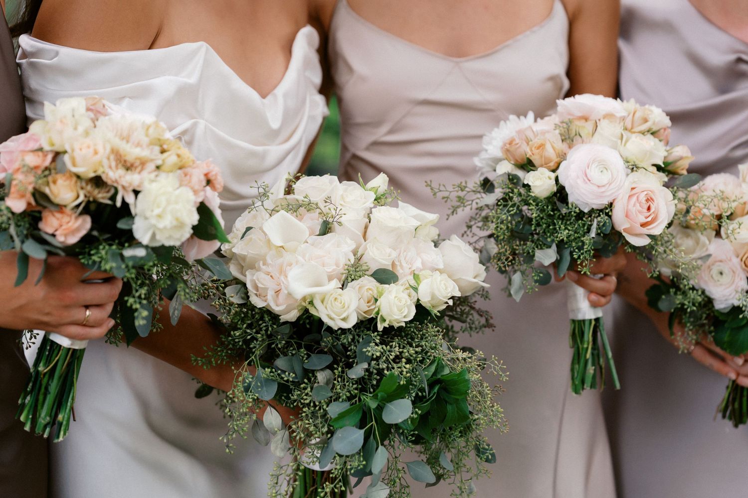 Three elegant wedding bouquets featuring white roses, pink flowers and greenery.