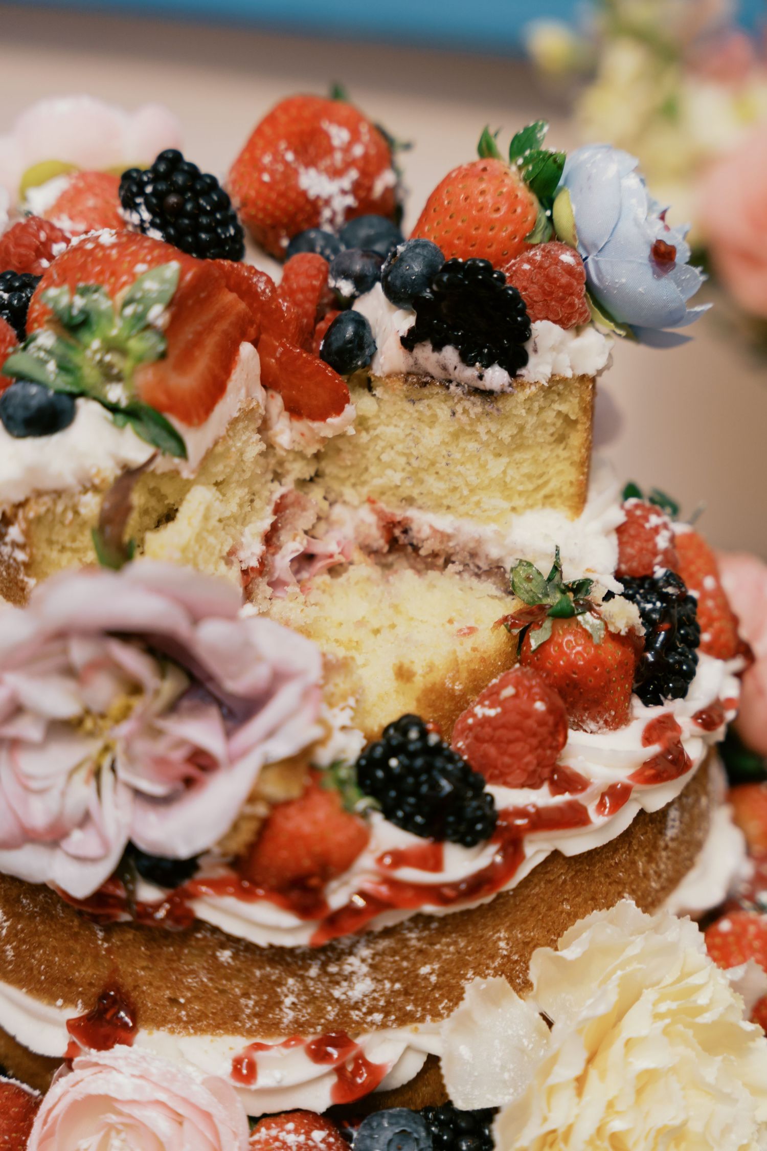 Close-up of gourmet appetizers with berries, cream, and sliced meat on toasted bread.