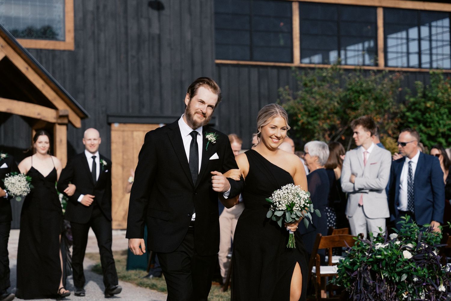 Rustic outdoor wedding ceremony setup with wooden benches and natural decor.