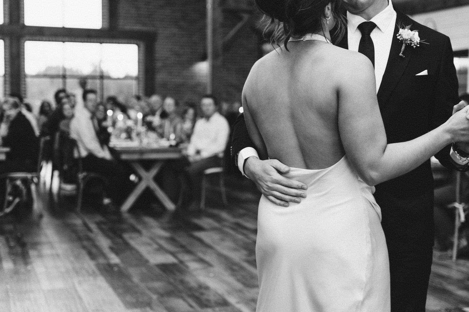 Couples dancing together at an indoor wedding reception.