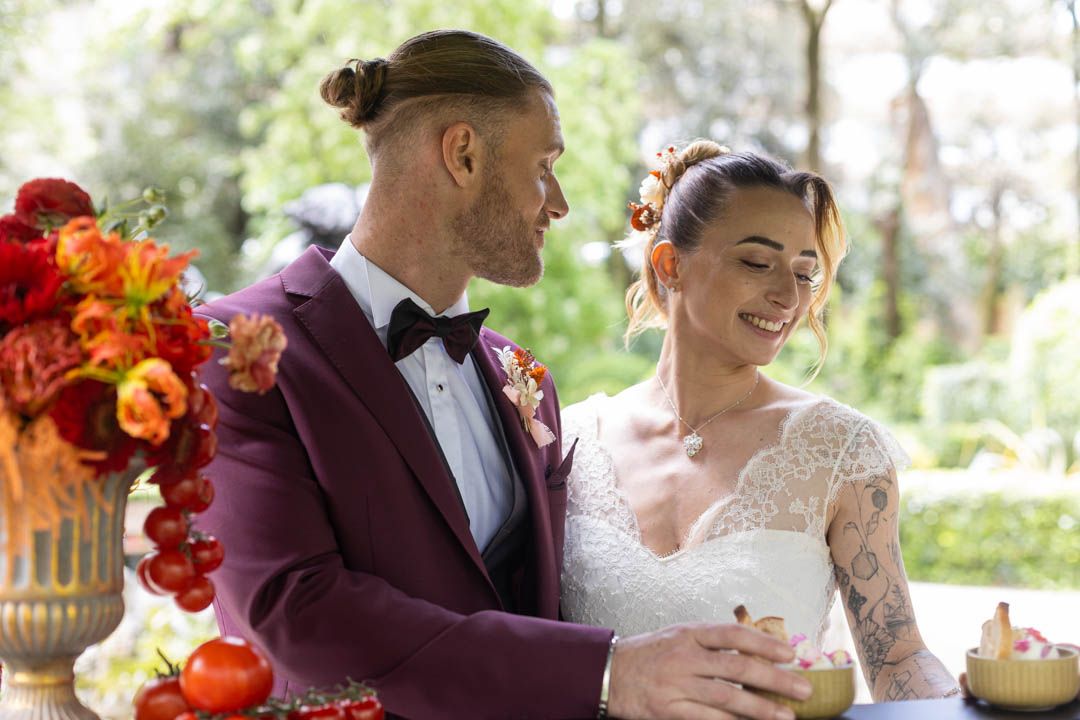 Wedding celebration in a lush garden setting with elegant table decorations.