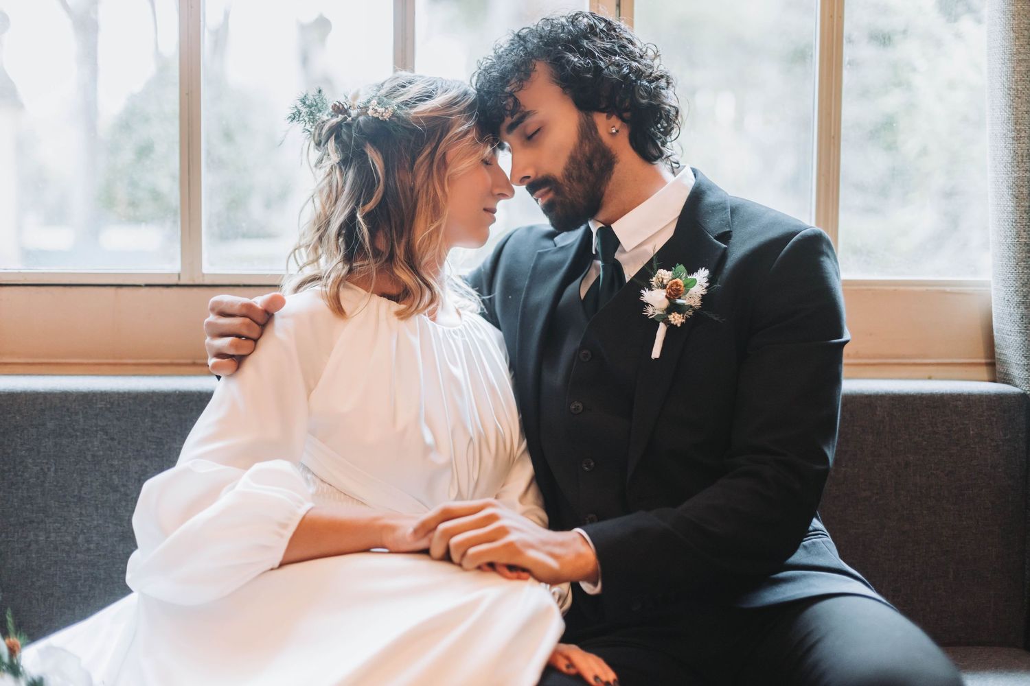 Intimate indoor wedding portraits with soft lighting and tender moments.