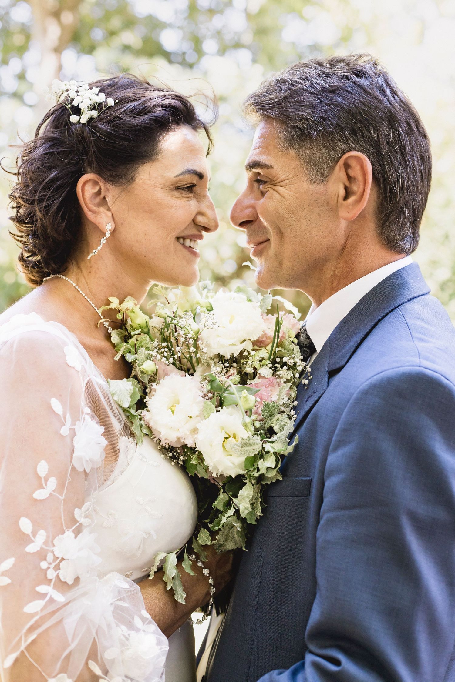 Wedding portrait sequence showing tender moments between newlyweds with white floral arrangement.