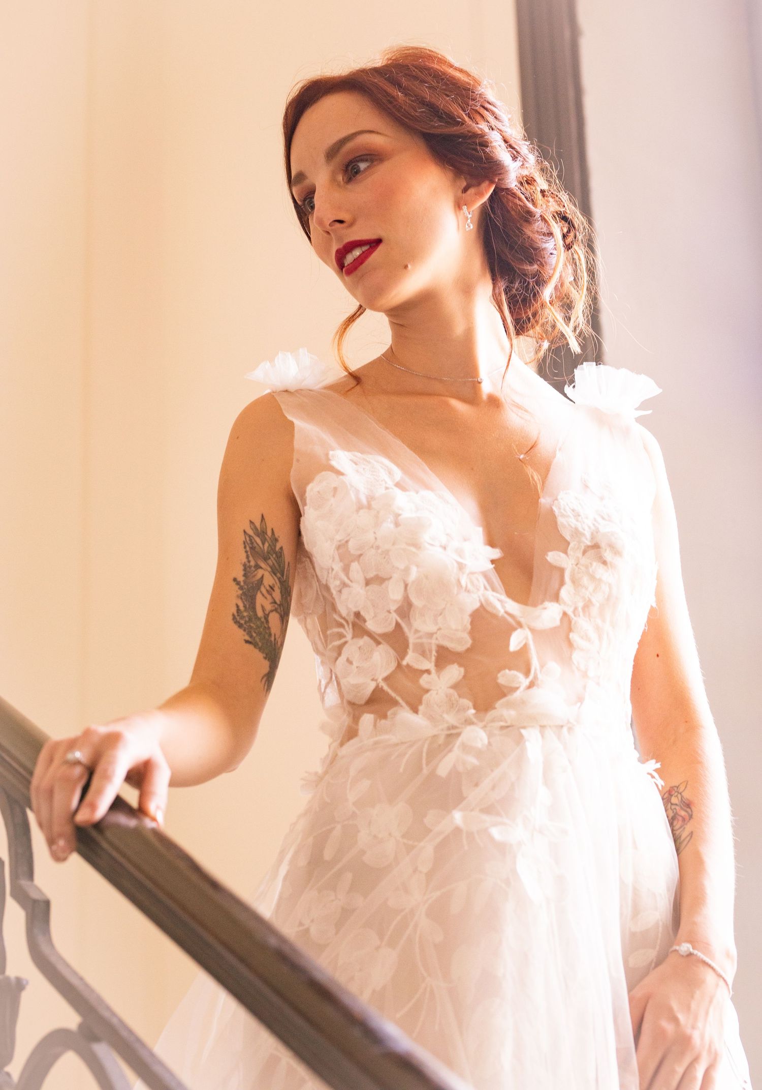 Elegant white wedding dress with floral appliques captured in natural light.