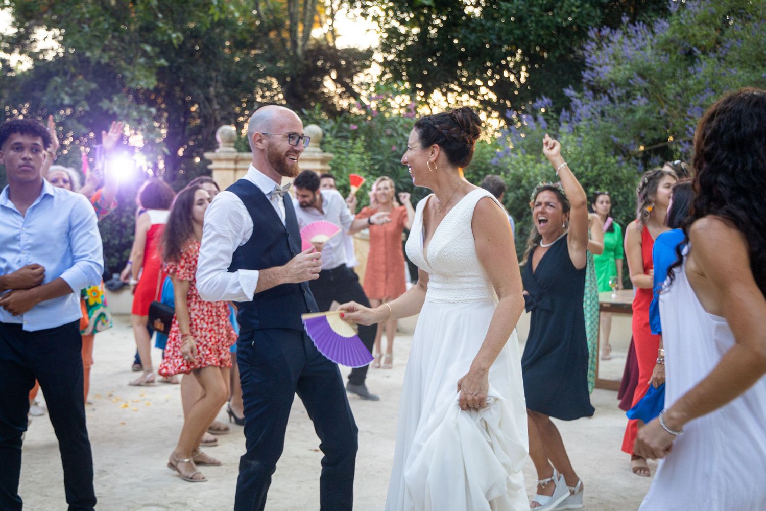 Guests enjoying a lively dance celebration at an outdoor wedding reception.