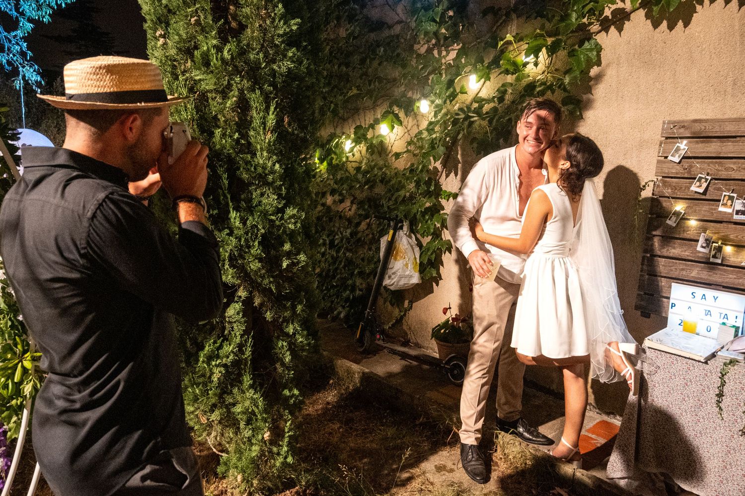 A romantic outdoor wedding scene with strings of glowing lights creating an intimate atmosphere.