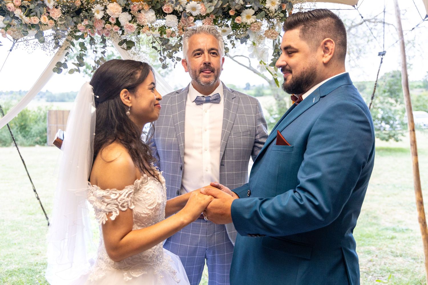 Wedding celebration with formal attire and microphones during outdoor ceremony.