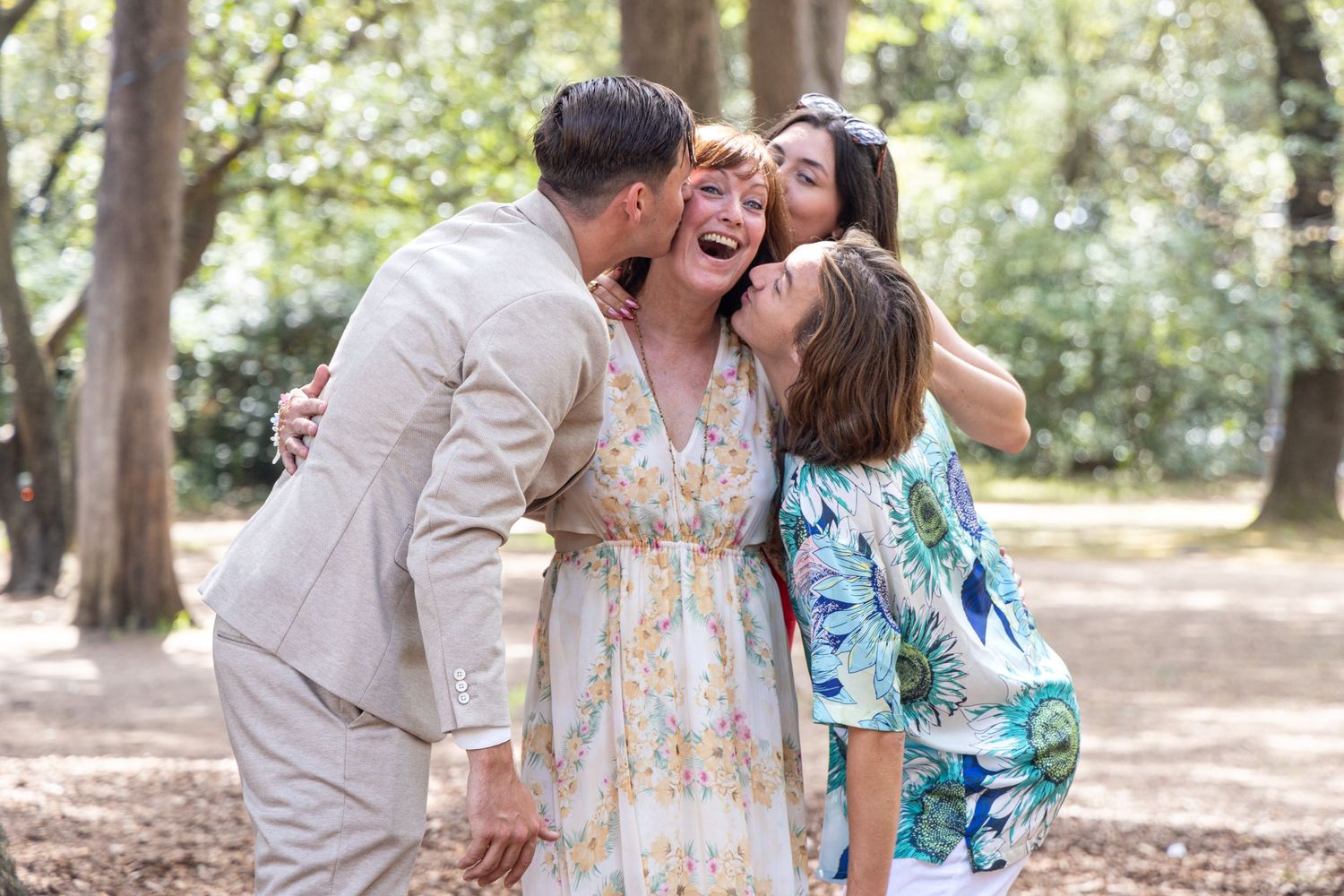 Group celebrating in an outdoor park setting among trees.