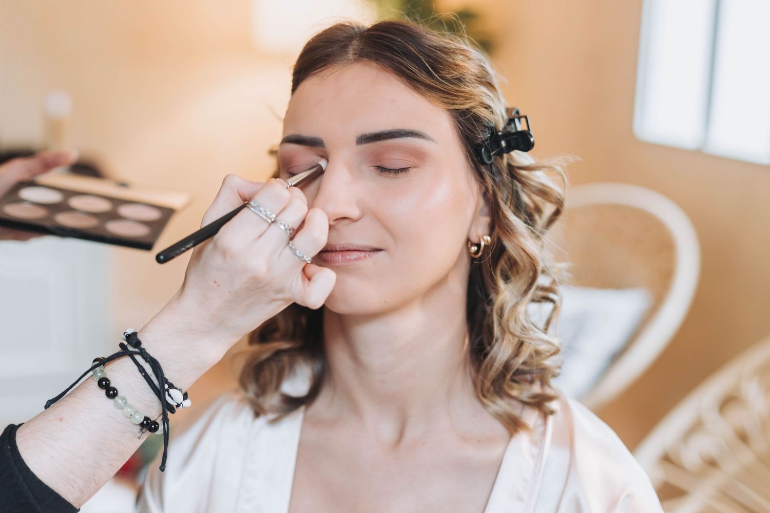 Close-up shot of wedding day makeup application showing eyeshadow being applied.