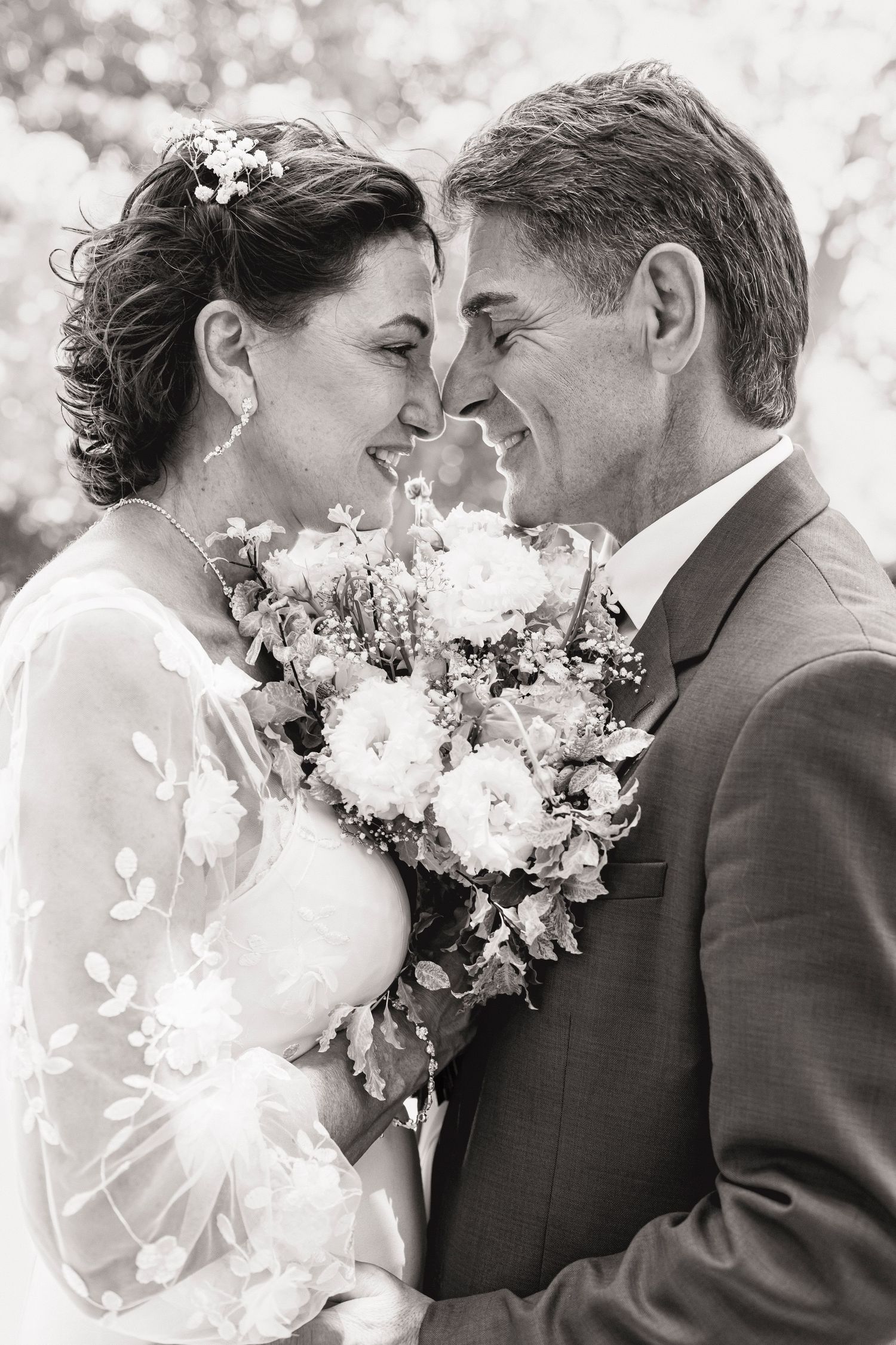 Black and white wedding photos capturing intimate moments between bride and groom.