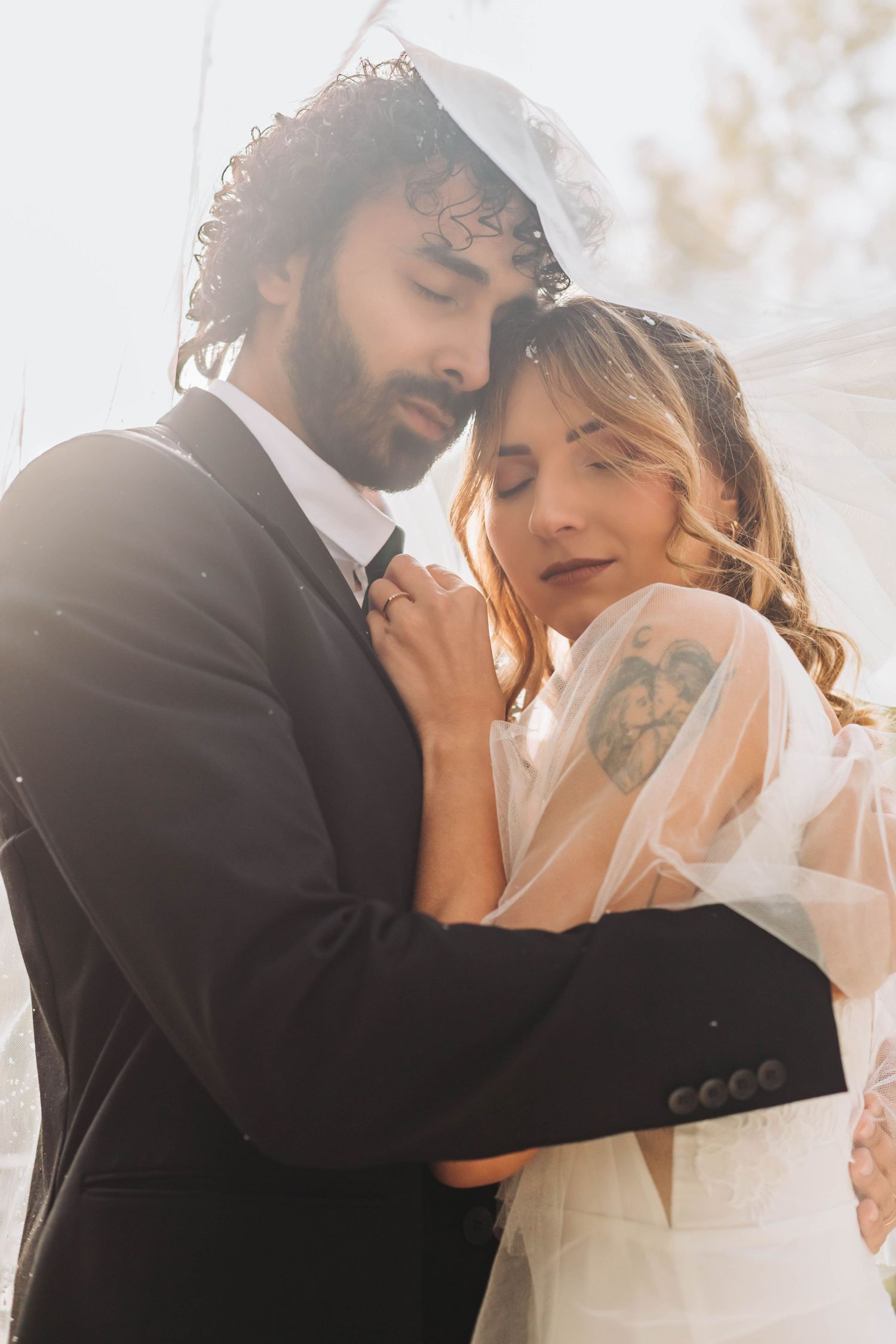 Romantic wedding portrait capturing an intimate embrace between bride and groom.