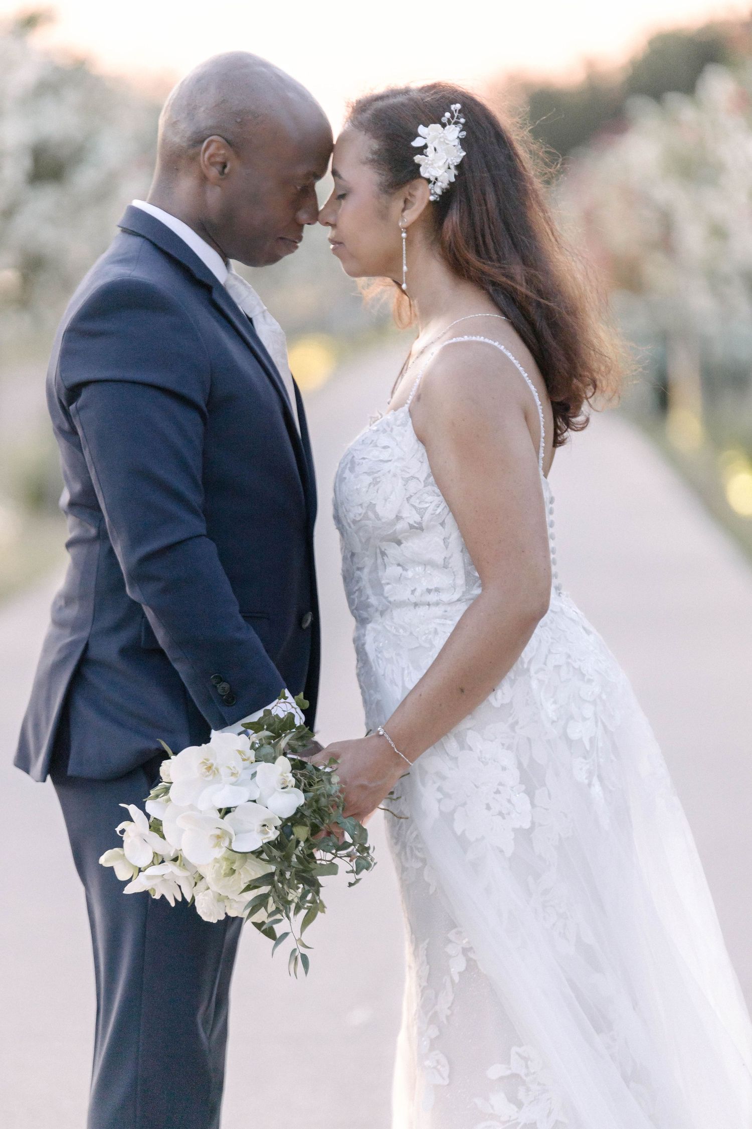 Tender moments between newlyweds captured during their outdoor wedding portraits.