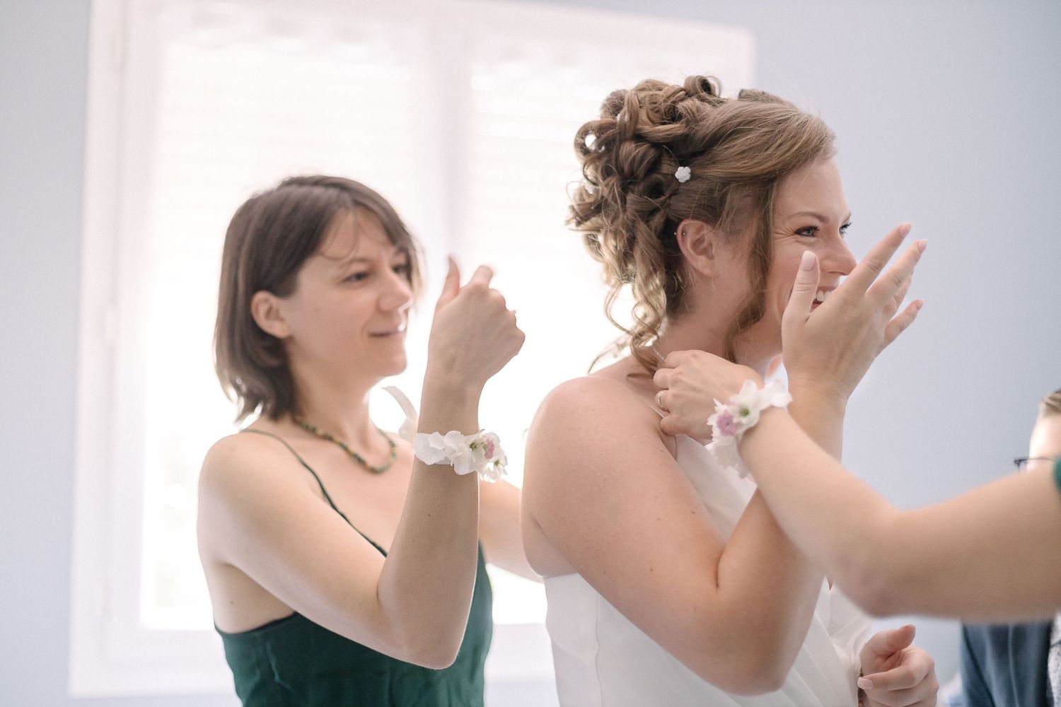 Applying bridal makeup and styling hair in preparation for a wedding day.