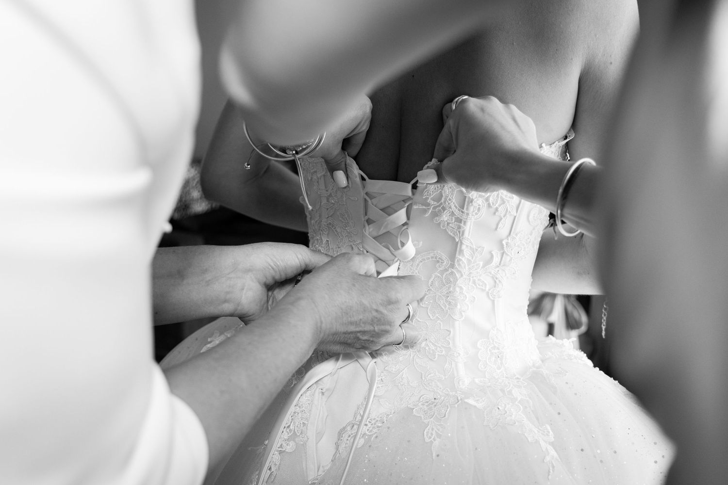 Close-up details of wedding dress buttons and lace.