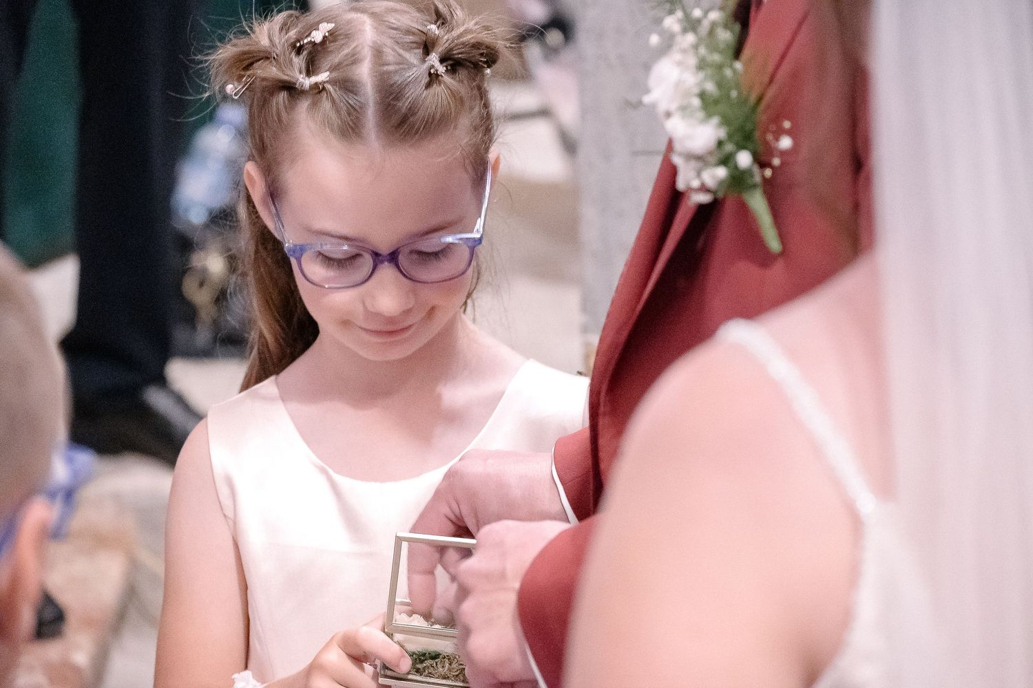 Young attendants in pink dresses preparing for a wedding ceremony.