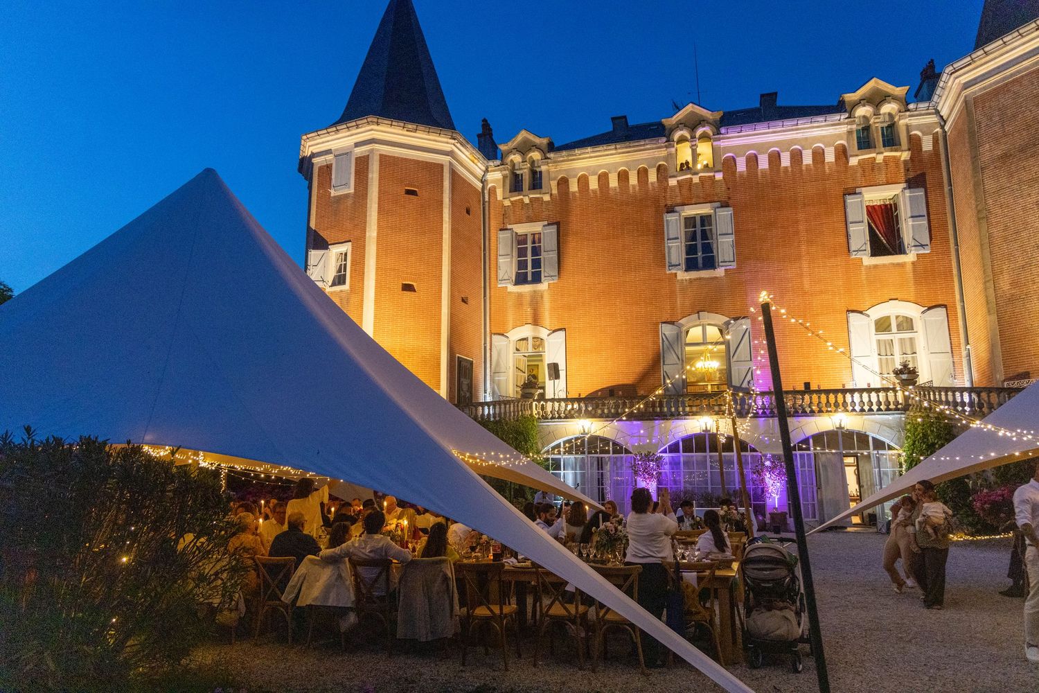 Historic stone building illuminated at night with elegant architectural features.
