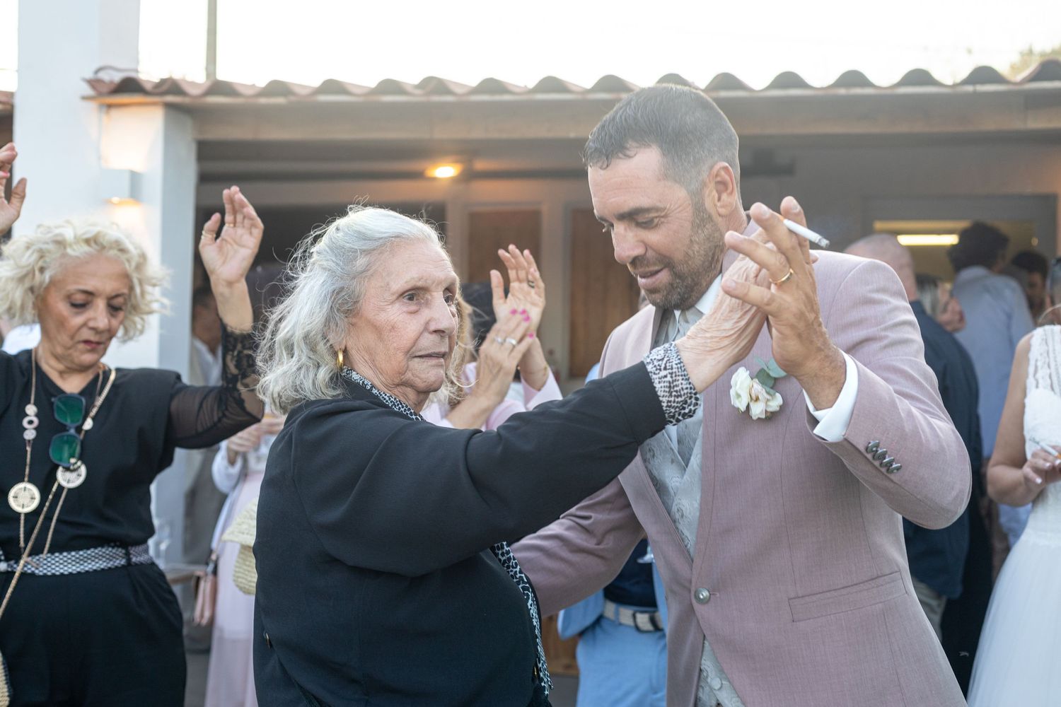 Guests dancing in formal attire at a celebration event.