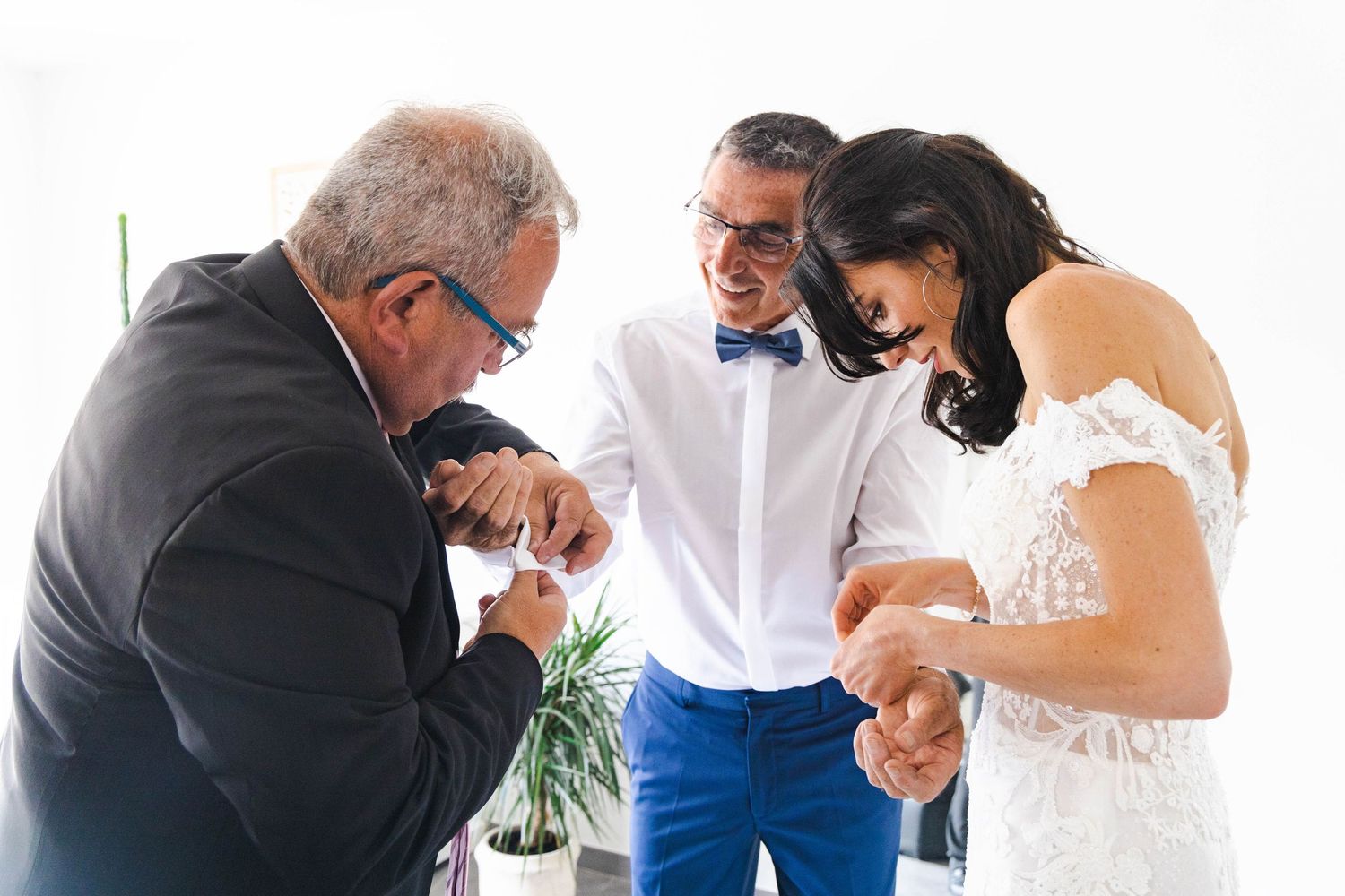 Family members assist with final wedding day preparations.